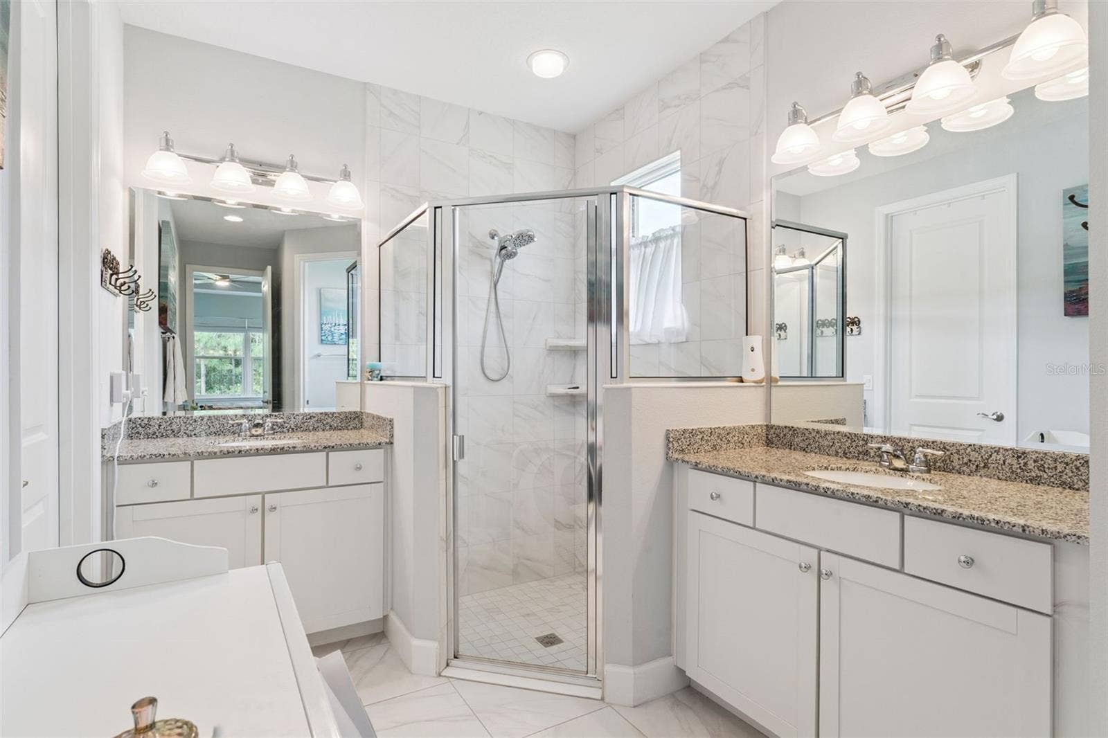 1305 HAYTON AVE., Deland, FL 32724 8' x 15' Primary Bathroom w/ separate granite countertop vanities, glass enclosed walk-in shower & bench seat