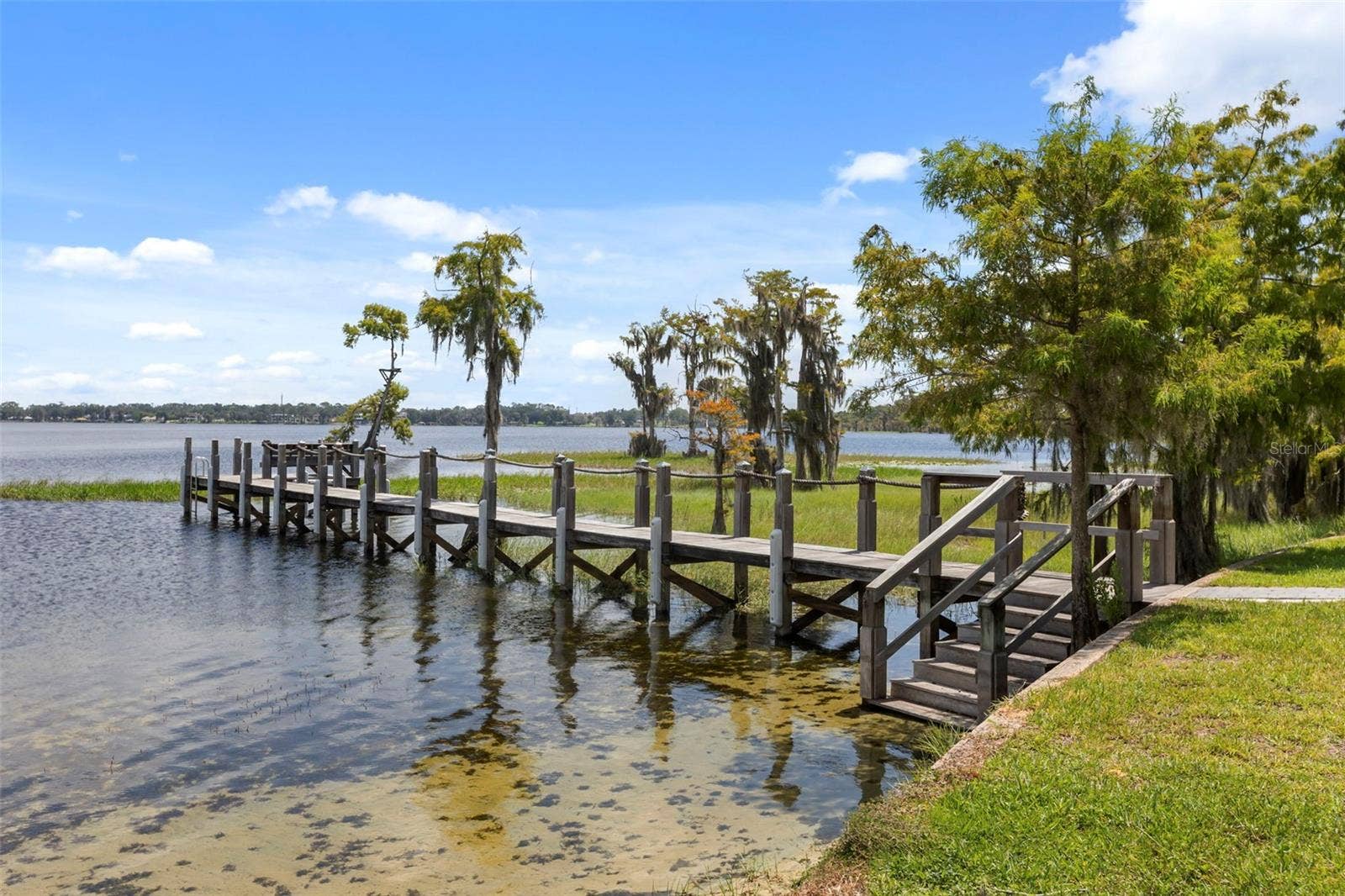 10430 LAKE COTTAGE LANE, Orlando, FL 32836 A private dock and boatlift provide access to Lake Sheen and the entire Butler Chain, while a gated community boat ramp is approximately 300 feet away.