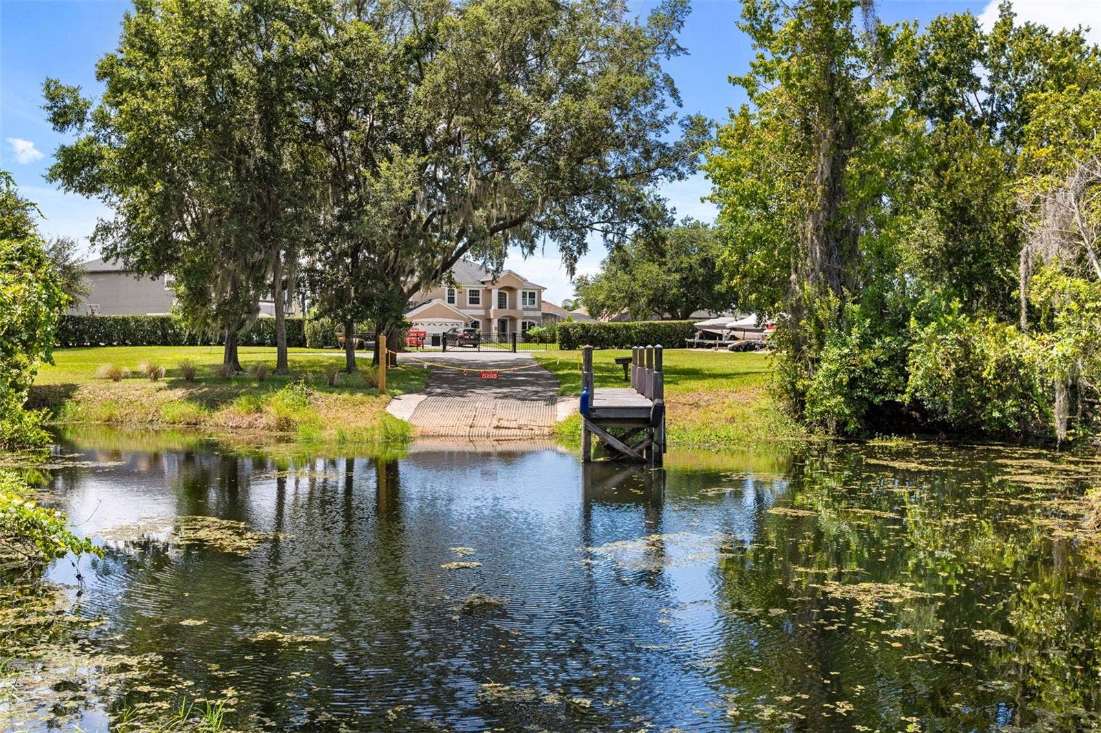 10430 LAKE COTTAGE LANE, Orlando, FL 32836 A private dock and boatlift provide access to Lake Sheen and the entire Butler Chain, while a gated community boat ramp is approximately 300 feet away.