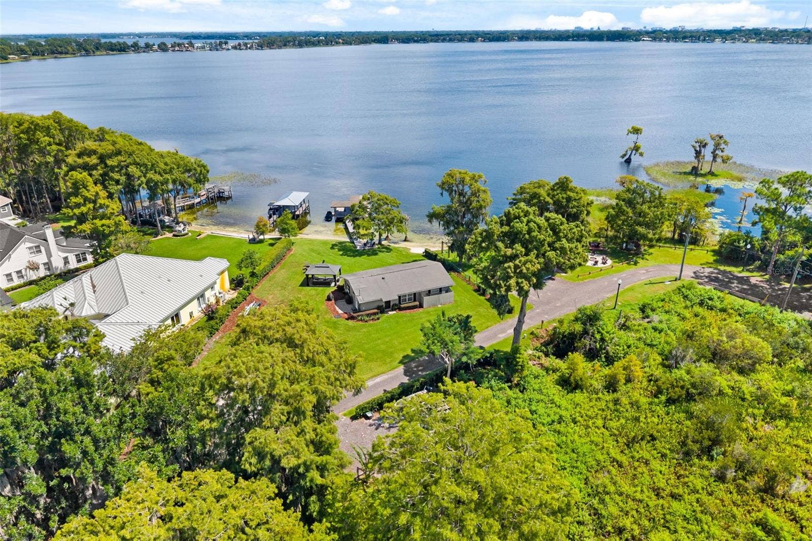 10430 LAKE COTTAGE LANE, Orlando, FL 32836 Rare Lake Sheen lakefront estate opportunity on the Butler Chain of Lakes! An exceptional opportunity to build a custom luxury lakefront residence on one of the most compelling properties along Lake Cottage Lane.