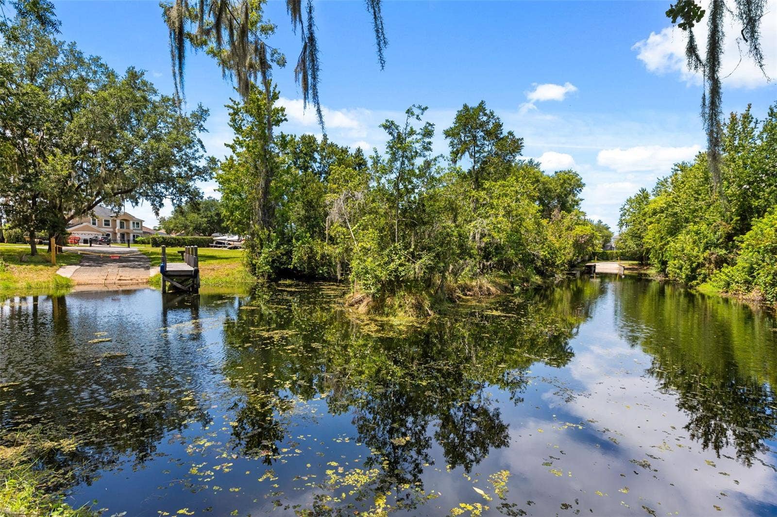 10430 LAKE COTTAGE LANE, Orlando, FL 32836 A private dock and boatlift provide access to Lake Sheen and the entire Butler Chain, while a gated community boat ramp is approximately 300 feet away.