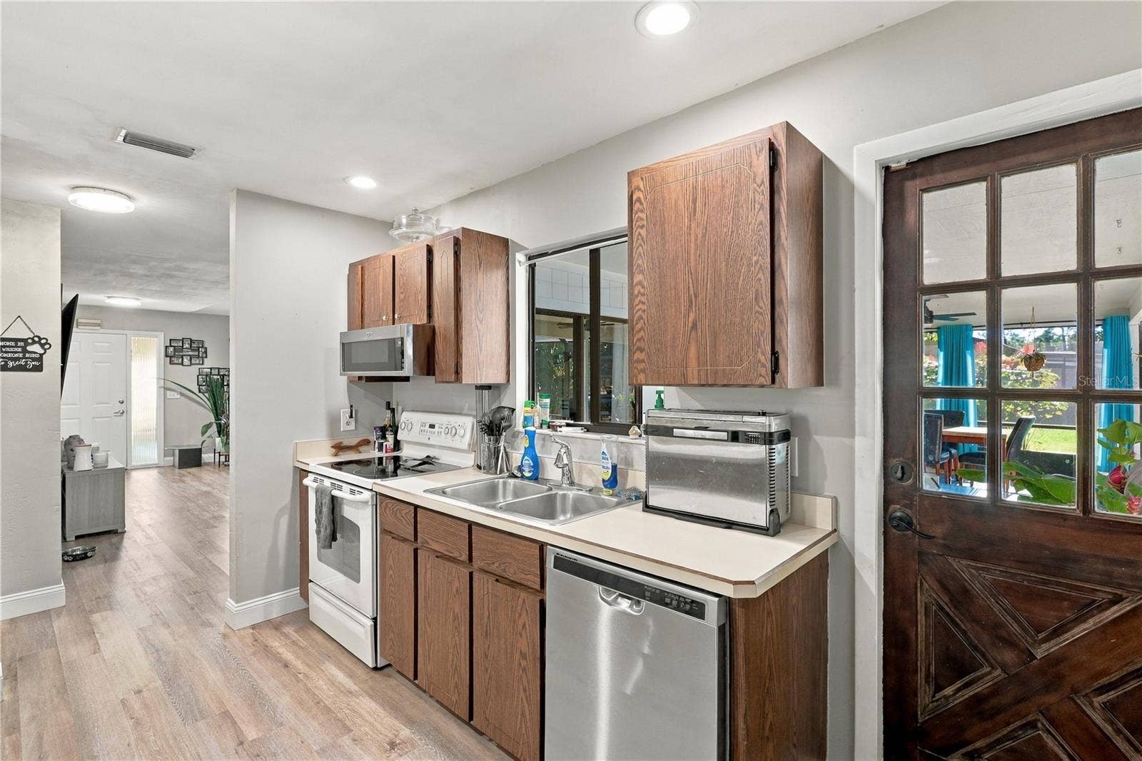 Kitchen View Toward Front Door, Window Overlooks Back Lanai, Door leads to Covered Lanai, Pool & Spa!