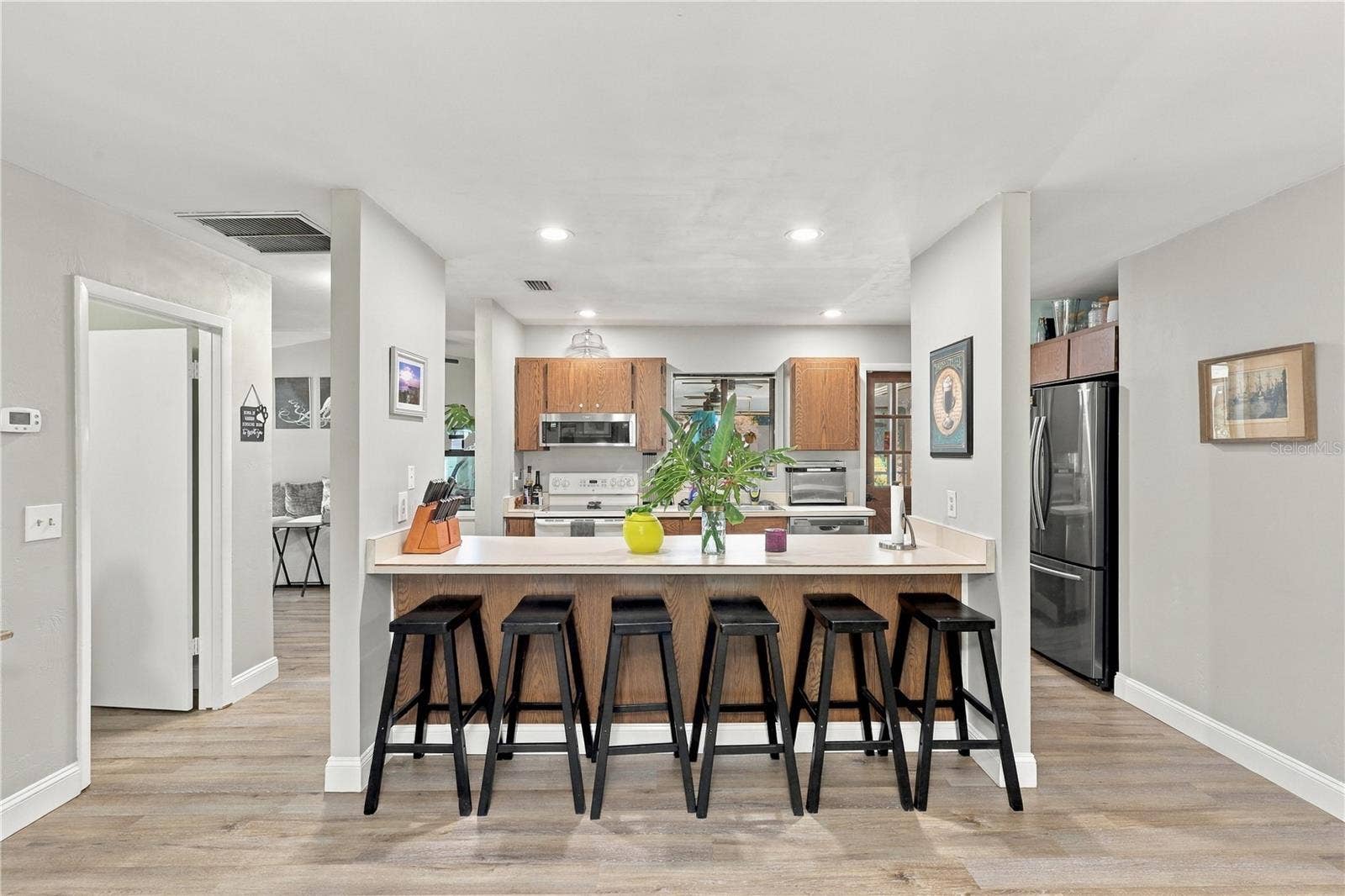 Kitchen, Breakfast Bar, Door to Interior Laundry and Garage on the Left.