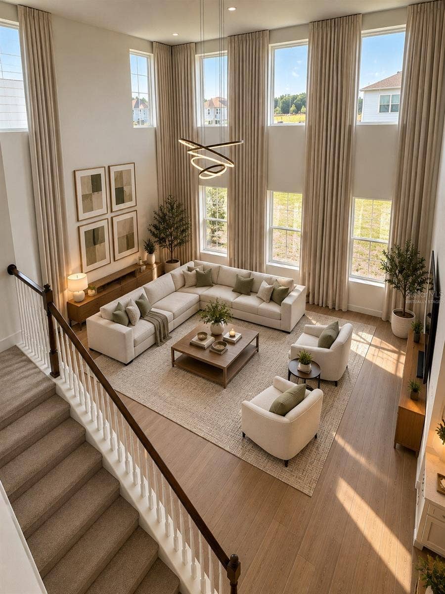 5714 CATTLE RANCH DRIVE, St Cloud, FL 34771 Virtually Staged.Experience the elegance of model-home living! This spectacular, light-filled living room features soaring double-height ceilings, expansive windows, and an impressive open-concept design. Bathed in natural light, this exceptionally spacious area offers a breathtaking sense of openness, sophistication, and comfortperfect for luxurious everyday living and entertaining.AI Virtual Staging Disclosure: This image has been virtually staged using artificial intelligence based on an original photograph of the actual living room. Furniture, dcor, and decorative elements are digitally generated for illustrative purposes and are not included with the rental property.