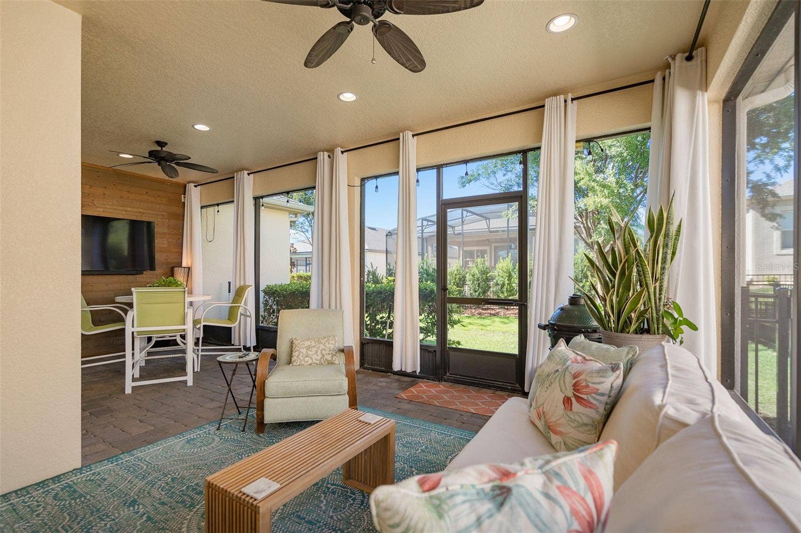 1038 TIMBERVALE TRAIL, Clermont, FL 34715 Enjoy the Screened Lanai with a Wood Accent Wall with TV connections, 2 Ceiling Fans and Pavers