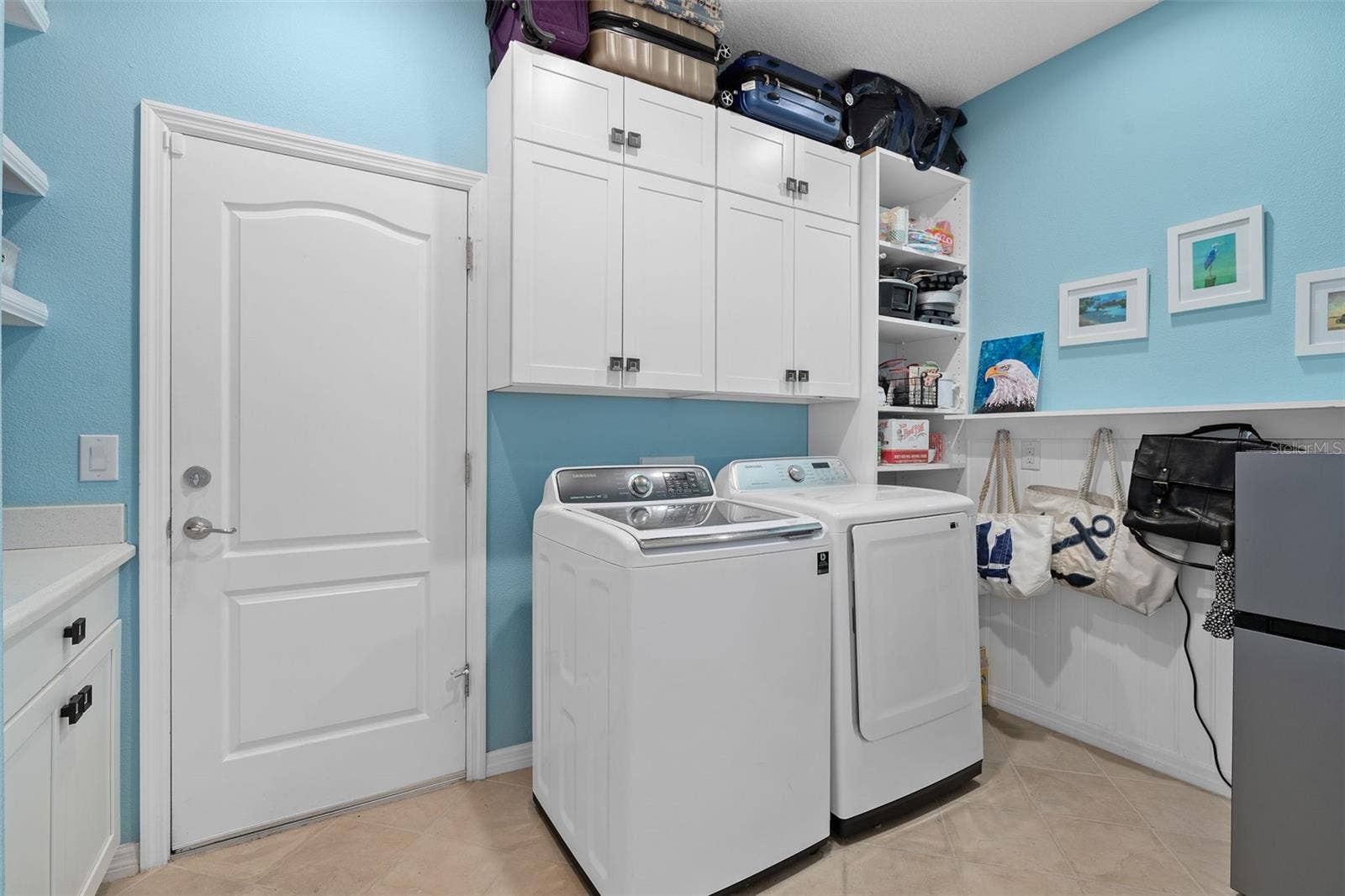 1038 TIMBERVALE TRAIL, Clermont, FL 34715 Laundry Room with a Drop Zone, Cabinetry and Custom Wall Treatment