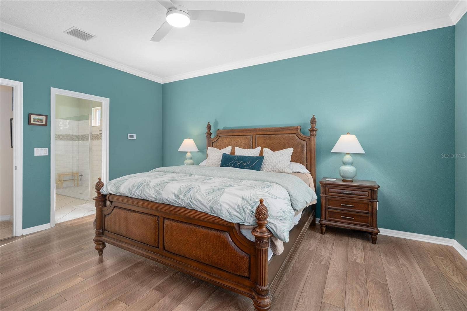 1038 TIMBERVALE TRAIL, Clermont, FL 34715 Primary Bedroom suite with Luxury Vinyl Plank Flooring Crown Molding with a view of the Primary En-Suite