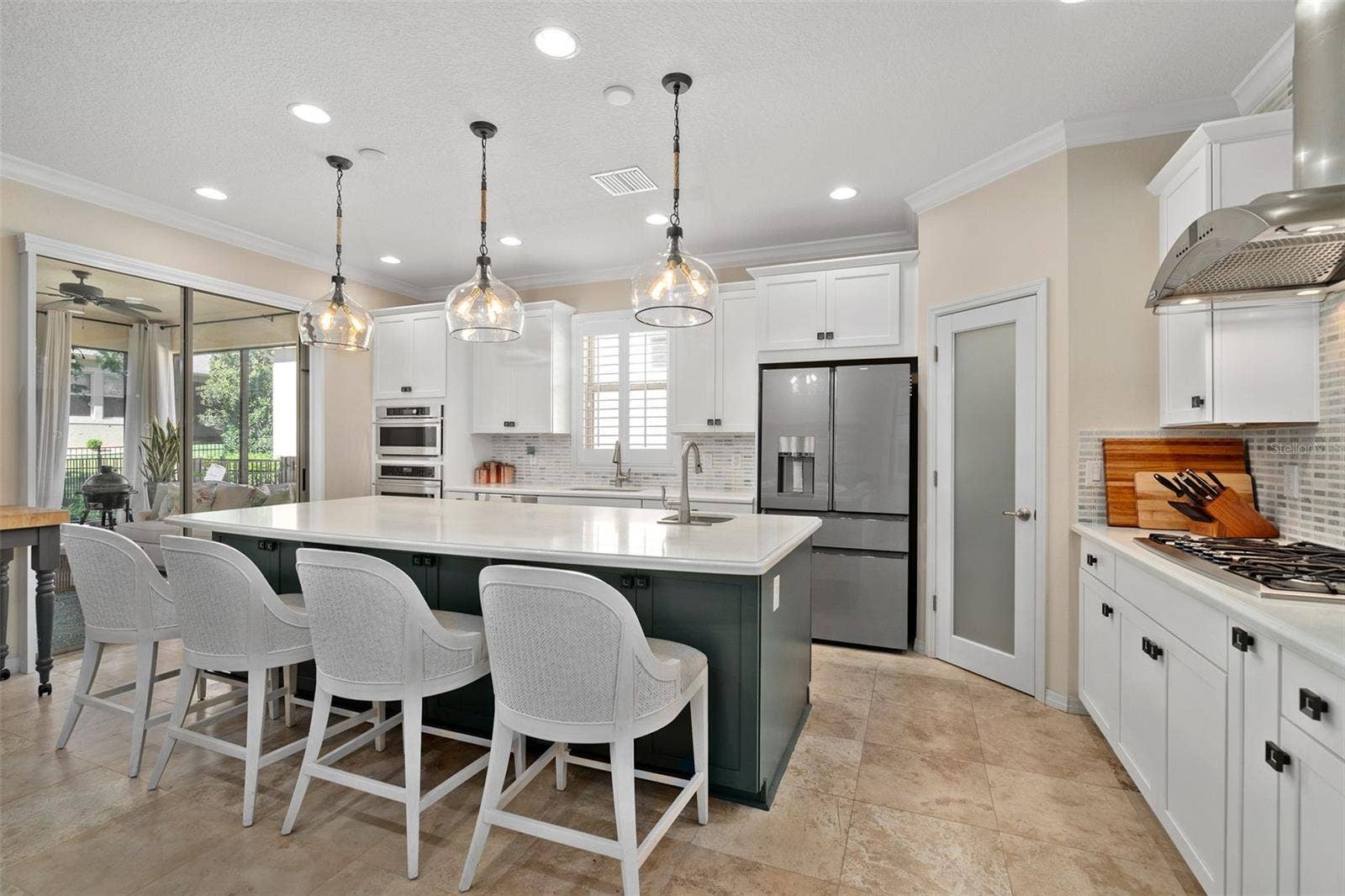1038 TIMBERVALE TRAIL, Clermont, FL 34715 The Gourmet kitchen option includes built-in Monogram Appliances (Cooktop, Built-in Convection Oven, Microwave and Wine Fridge) a Cafe' Glass Front Refrigerator (newer). Island prep sink, Breakfast Bar and Front Facing Cabinetry for additional storage.