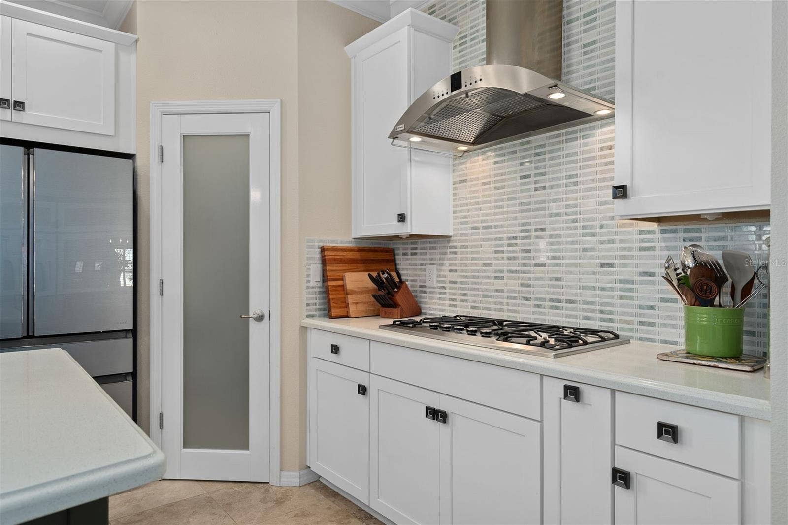 1038 TIMBERVALE TRAIL, Clermont, FL 34715 Corner Pantry with a Custom Frosted Glass Door. The Pantry has been outfitted with Custom Organization including a Lazy Susan.