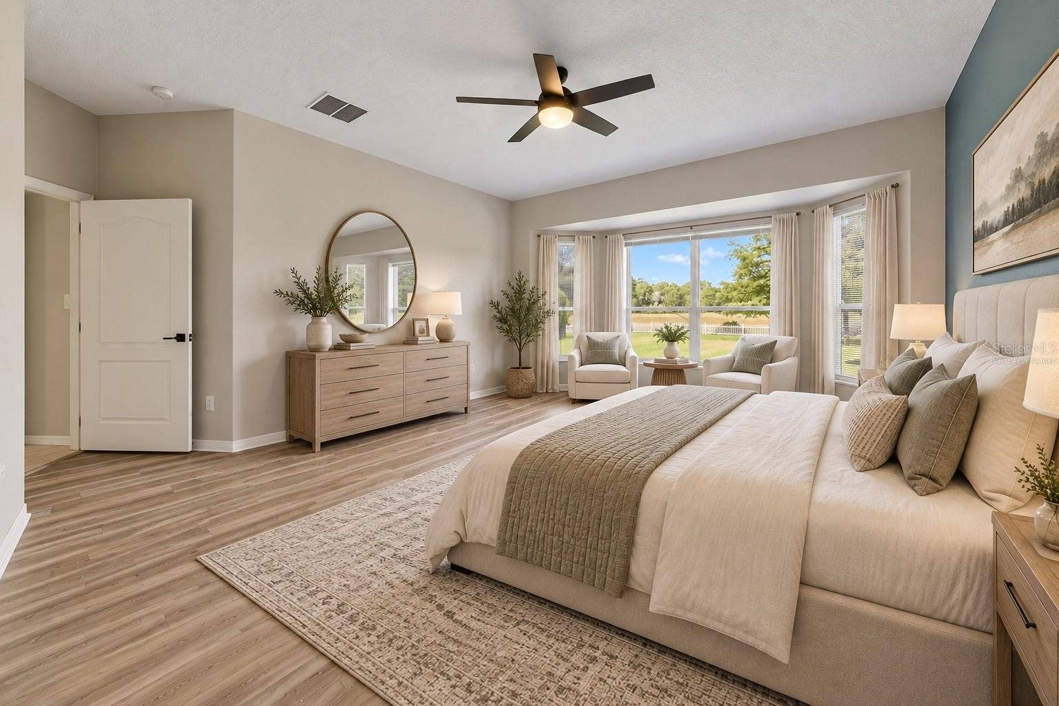 1557 AMARYLLIS CIRCLE, Orlando, FL 32825 The FIRST-FLOOR PRIMARY SUITE presents a private retreat with LVP FLOORING and a bay window that fills the room with NATURAL LIGHT. Virtually Staged