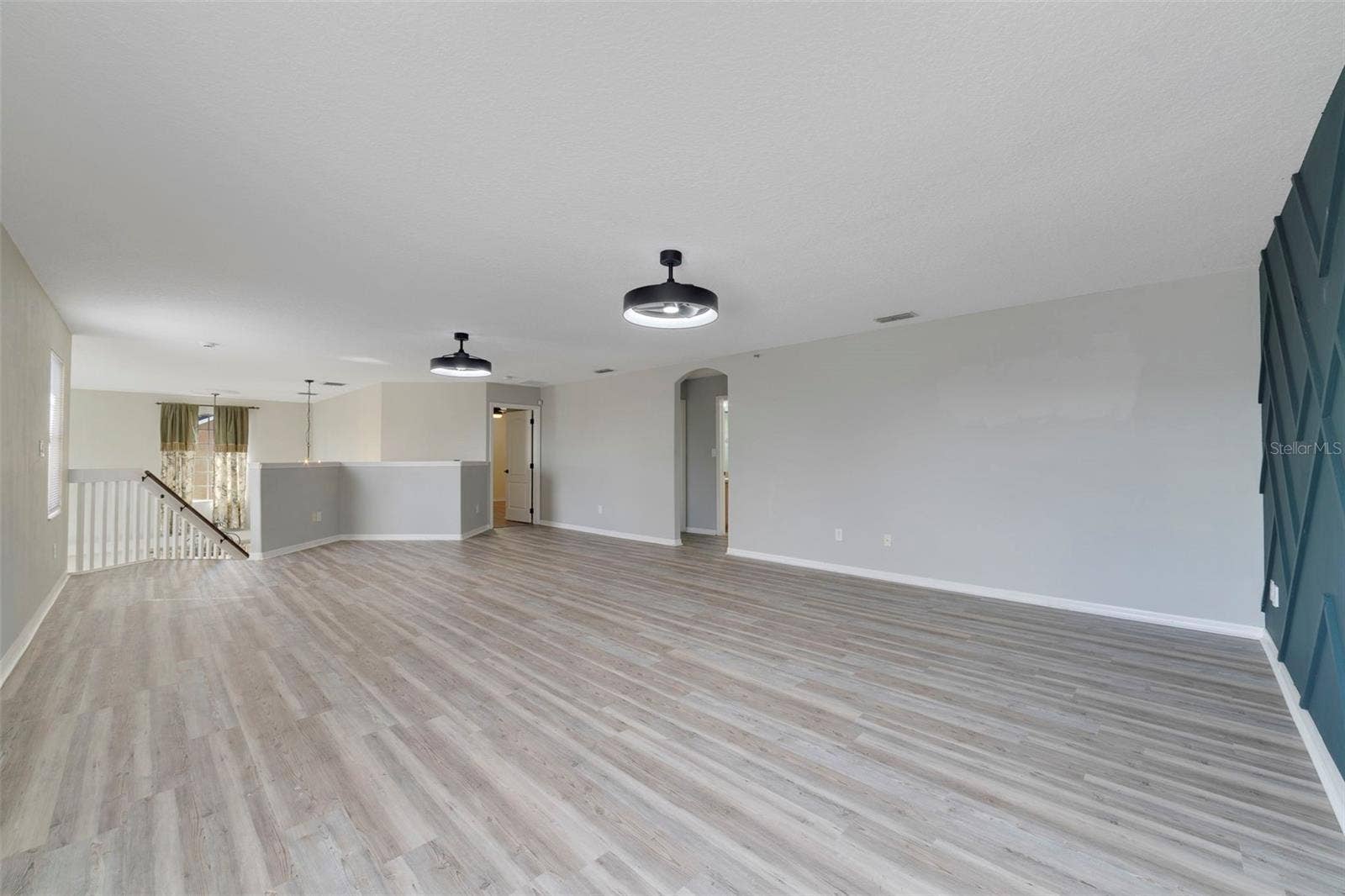 1557 AMARYLLIS CIRCLE, Orlando, FL 32825 Upstairs, a HUGE LOFT with UPDATED LIGHT/FAN FIXTURES and an accent wall, provides valuable flex space for a media room, game room, home office or additional lounge area.