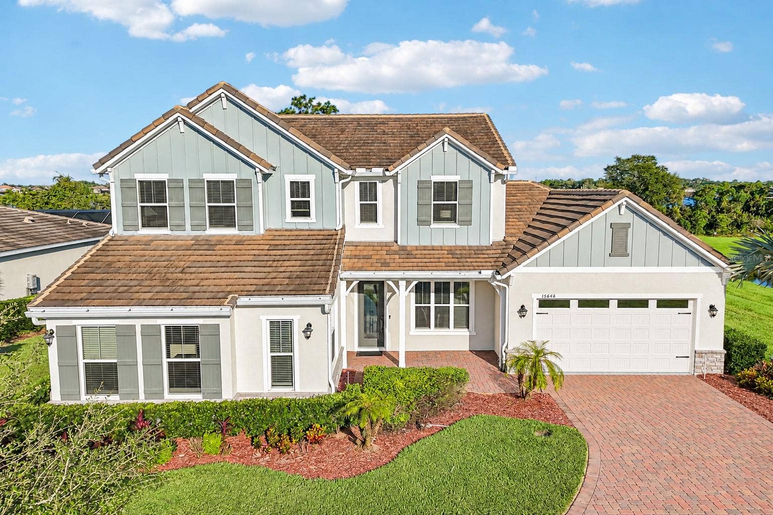 15646 SWEET LEMON WAY, Winter Garden, FL 34787 BUILT IN 2021, this beautifully upgraded 5-bedroom, 3.5-bath home sits on an OVERSIZED .37 ACRE CUL-DE-SAC LOT overlooking LAKE HUCKLEBERRY in the Highlands at Summerlake Groves community!