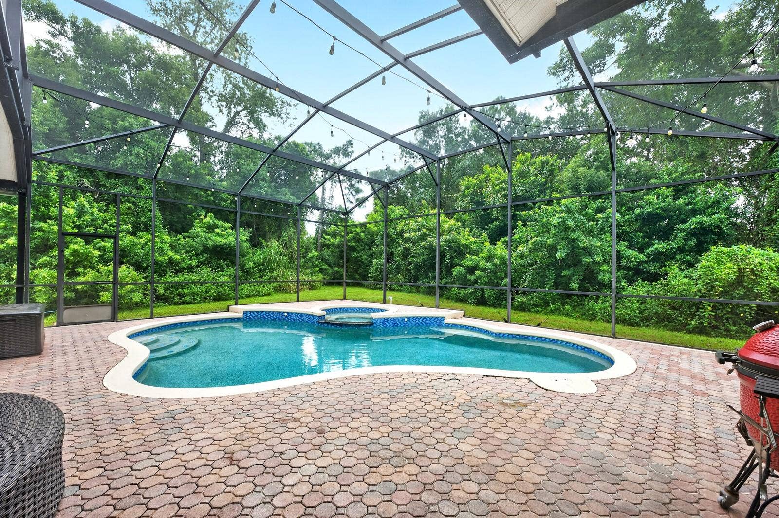 609 VIANA COURT, Winter Springs, FL 32708 Private screeed pool and spa surrounded by beautiful mature trees.