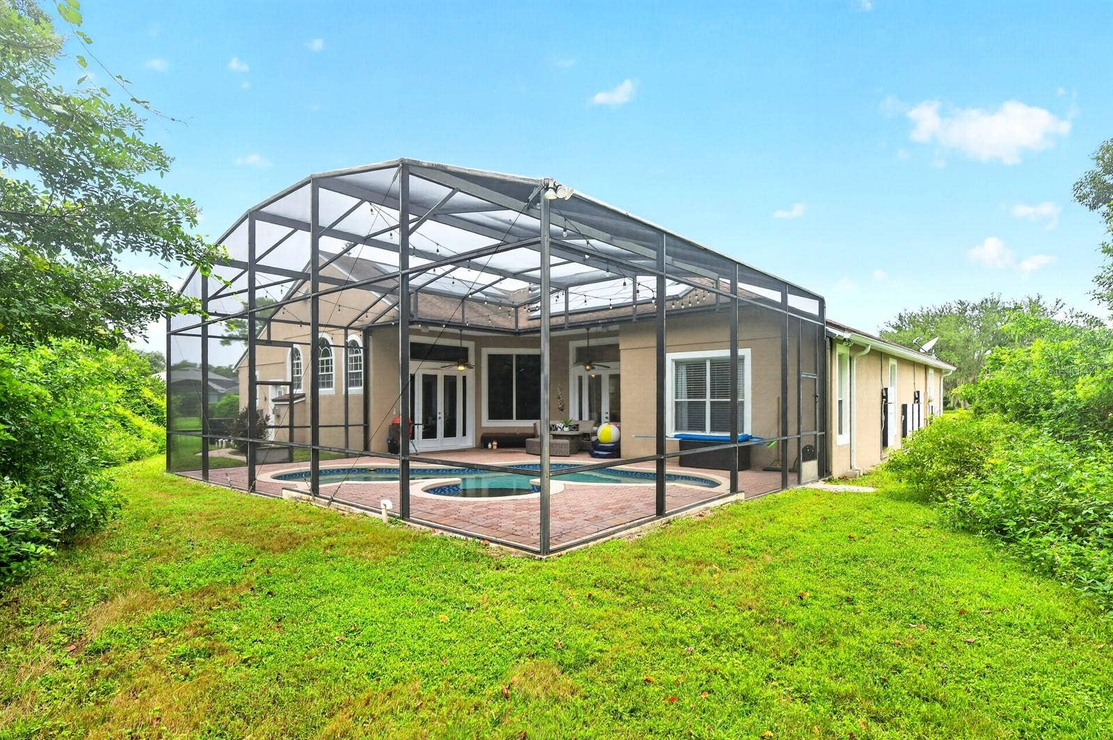 609 VIANA COURT, Winter Springs, FL 32708 Mature trees add privacy to the screened pool.