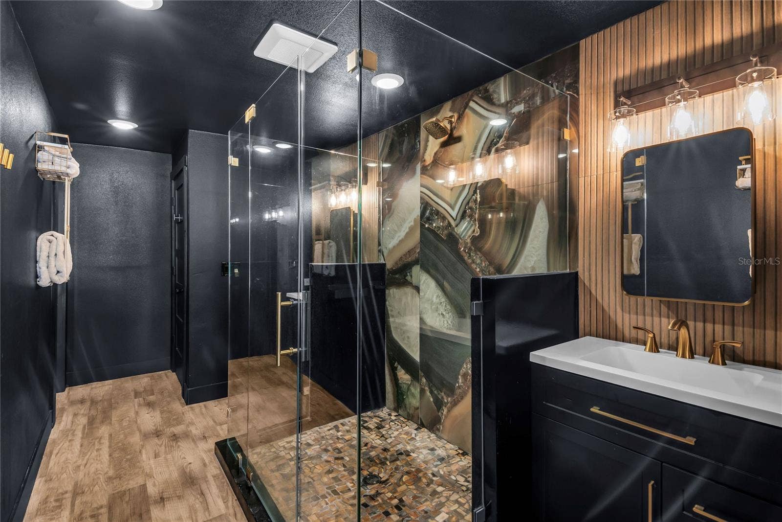 234 N LAKEVIEW AVENUE, Winter Garden, FL 34787 Oversized spa inspired bathroom features with dual vanities, two private water closets, a large glass-enclosed shower and elevated finishes throughout