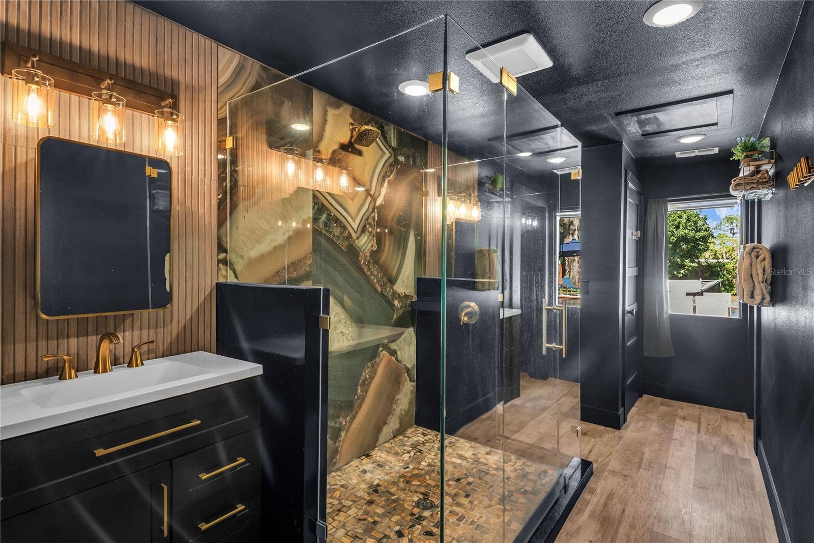 234 N LAKEVIEW AVENUE, Winter Garden, FL 34787 Oversized spa inspired bathroom features with dual vanities, two private water closets, a large glass-enclosed shower and elevated finishes throughout