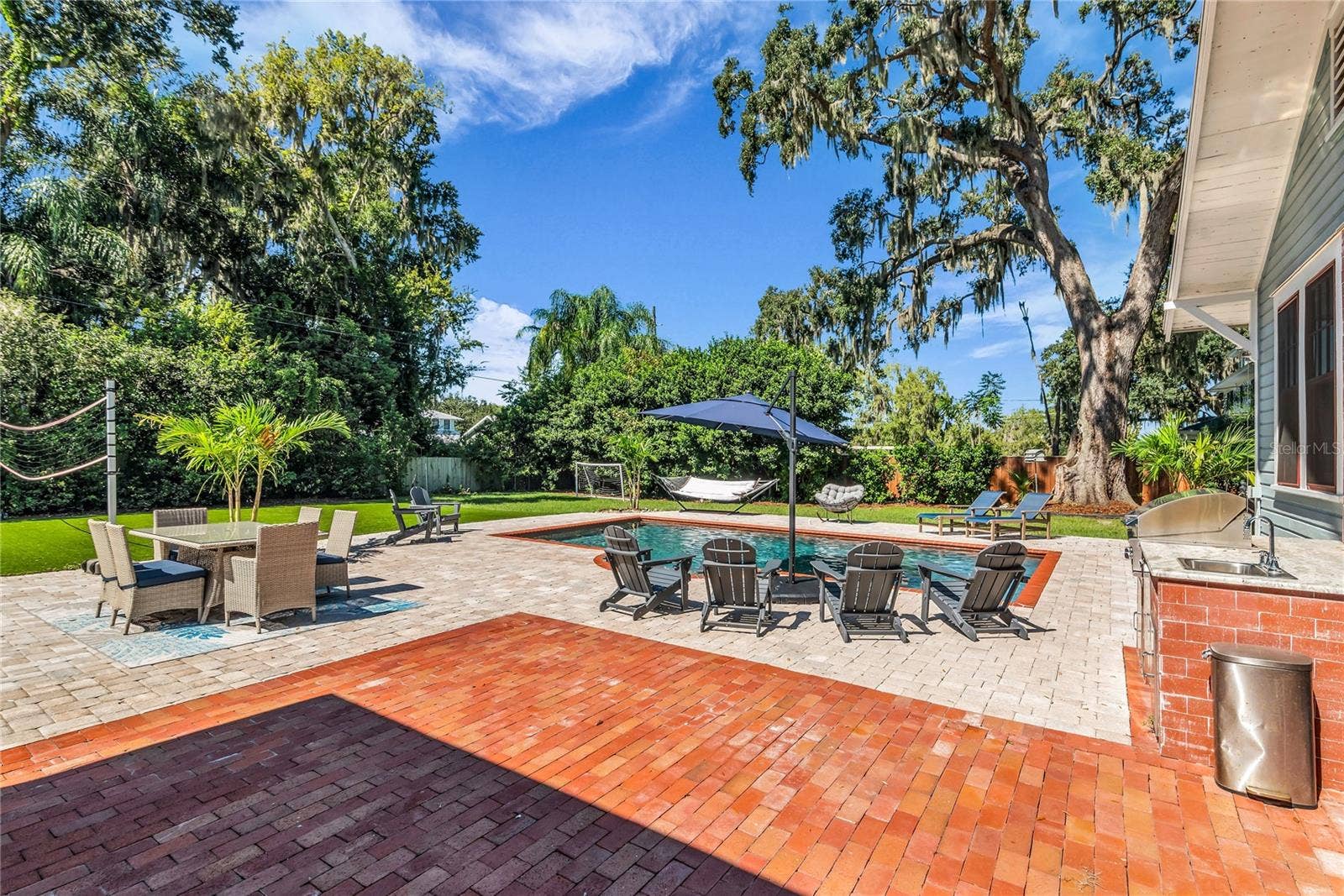 234 N LAKEVIEW AVENUE, Winter Garden, FL 34787 The enormous fully fenced backyard is designed for year-round enjoyment with a gas-heated saltwater sport pool, outdoor kitchen, expansive brick paved deck, detached covered lanai, and low-maintenance turf.