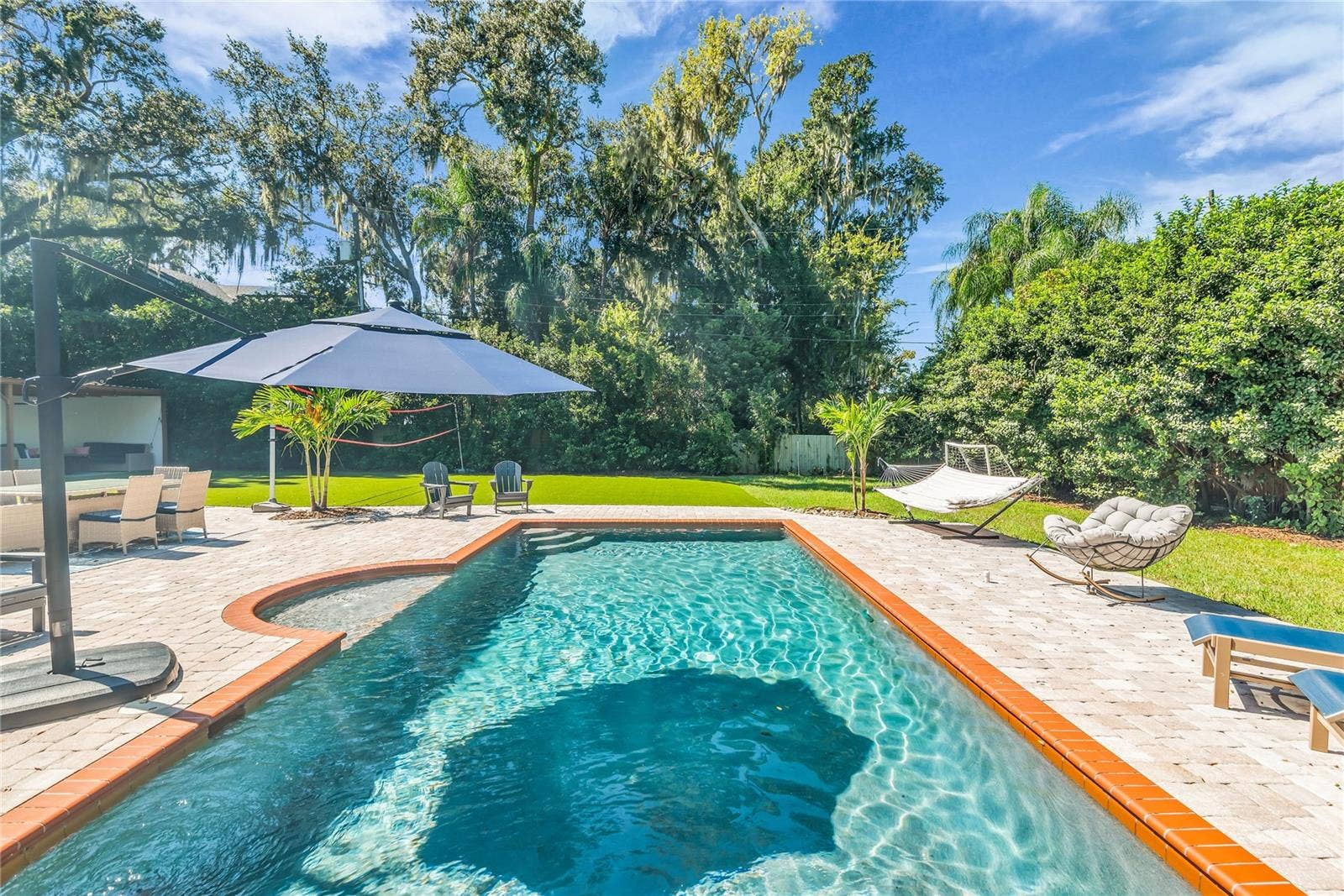 234 N LAKEVIEW AVENUE, Winter Garden, FL 34787 The enormous fully fenced backyard is designed for year-round enjoyment with a gas-heated saltwater sport pool, outdoor kitchen, expansive brick paved deck, detached covered lanai, and low-maintenance turf.