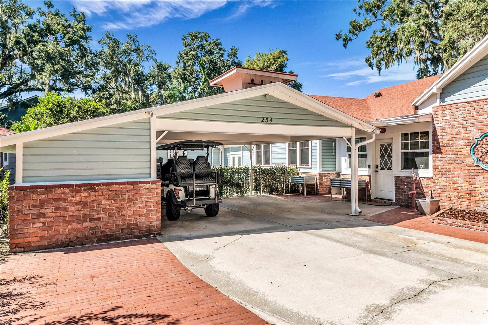 234 N LAKEVIEW AVENUE, Winter Garden, FL 34787 Double Carport includes both a Tesla and golf cart charging station as well as a large storage closet equipped with power and a shop desk.
