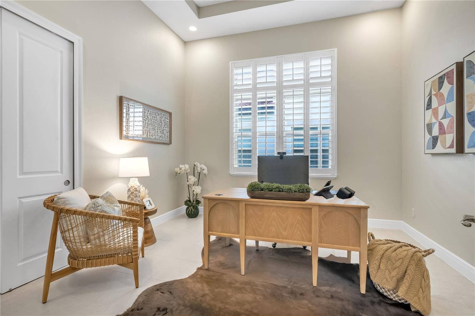 15749 CUTTER SAIL PLACE, Winter Garden, FL 34787 Dedicated home office featuring a tray ceiling, plantation shutters, and natural light.