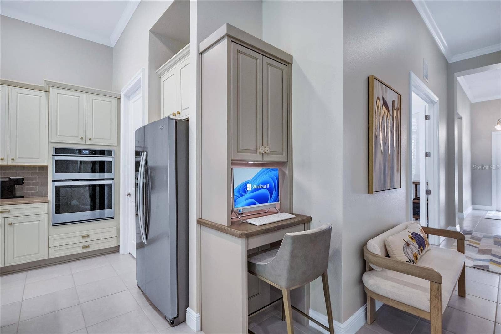15749 CUTTER SAIL PLACE, Winter Garden, FL 34787 Convenient built-in computer workstation located just off the kitchen, featuring custom cabinetry and a dedicated workspace perfect for everyday tasks, organization, or working from home.