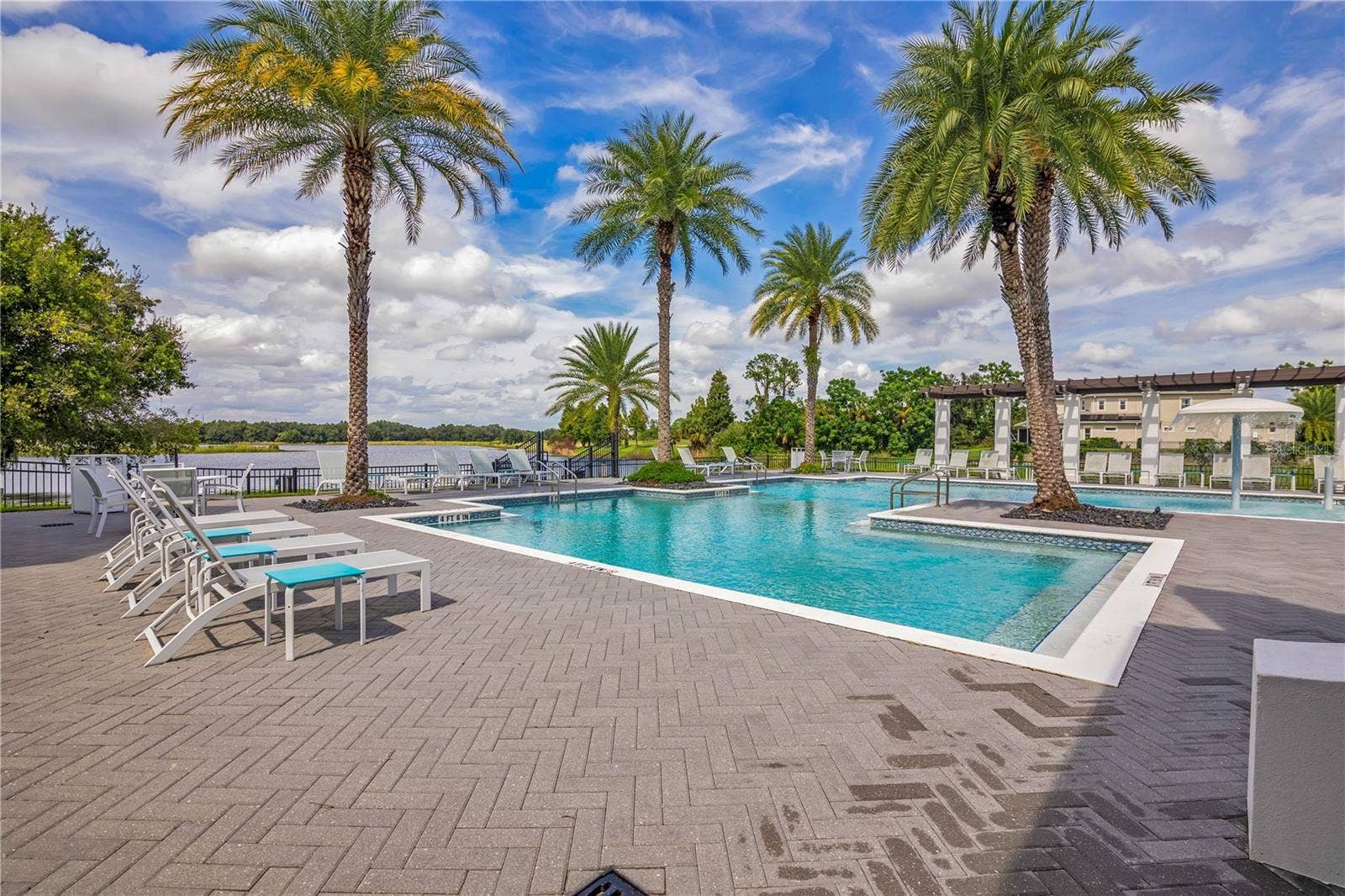 15749 CUTTER SAIL PLACE, Winter Garden, FL 34787 Relax and unwind at the stunning resort-style community pool surrounded by tropical landscaping.