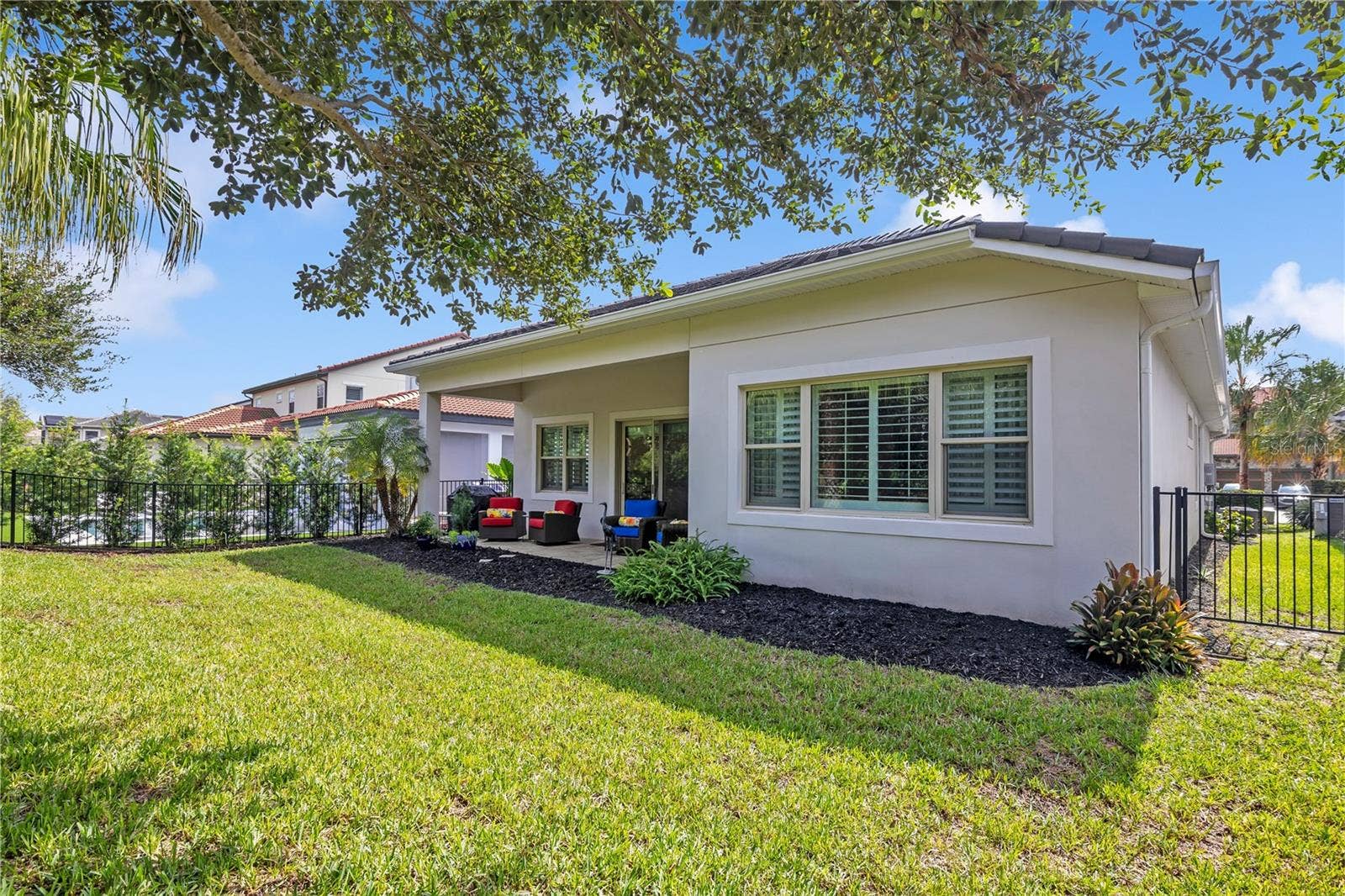 15749 CUTTER SAIL PLACE, Winter Garden, FL 34787 eautifully maintained backyard with lush green lawn, mature landscaping, and attractive fencing.