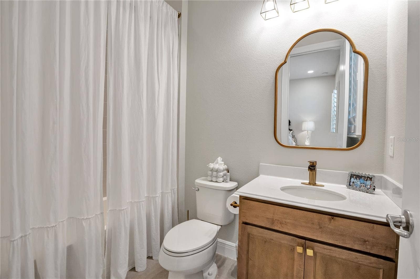 15749 CUTTER SAIL PLACE, Winter Garden, FL 34787 Bright bathroom featuring a contemporary vanity and stylish fixtures.