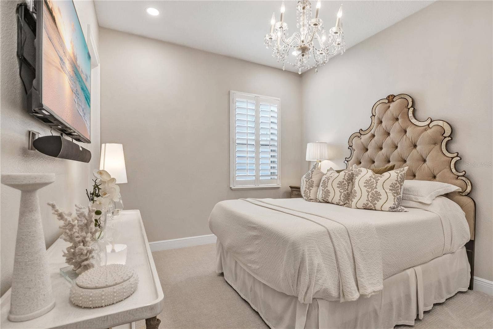 15749 CUTTER SAIL PLACE, Winter Garden, FL 34787 Beautifully appointed bedroom featuring a crystal-style chandelier and plantation shutters.