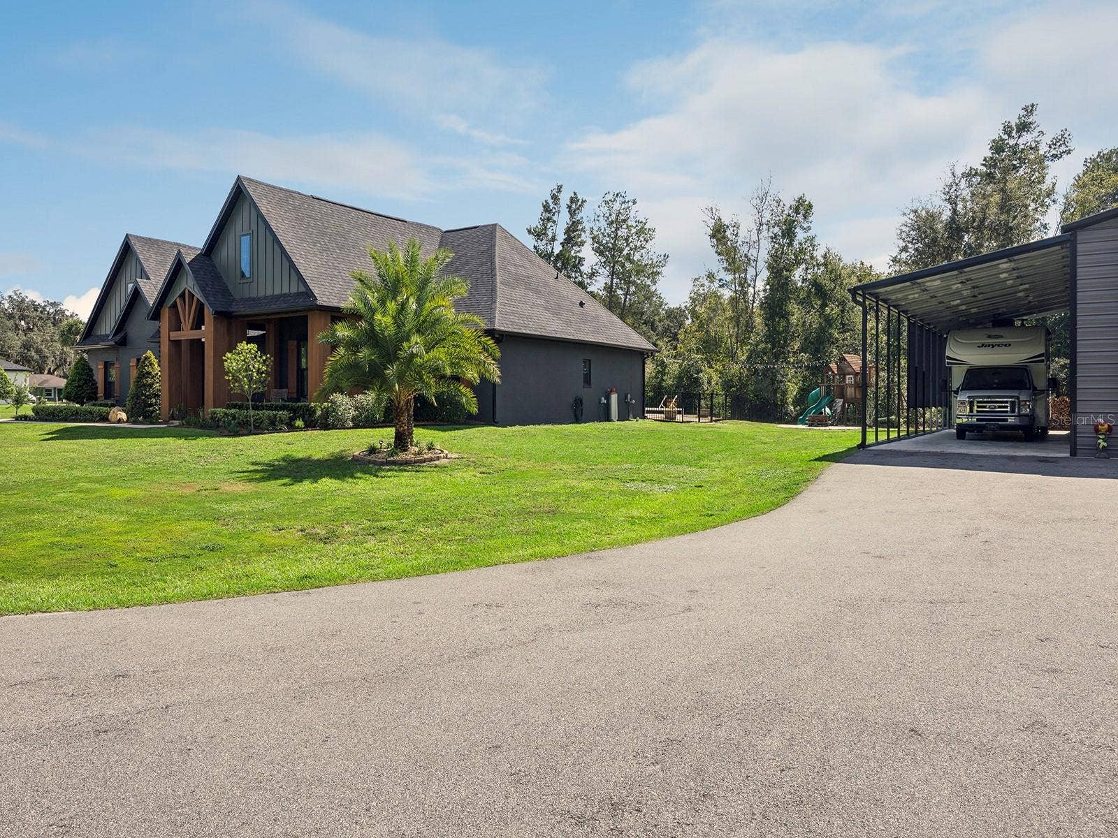 412 SNOW HILL RD, Geneva, FL 32732 Exterior of home and RV carport