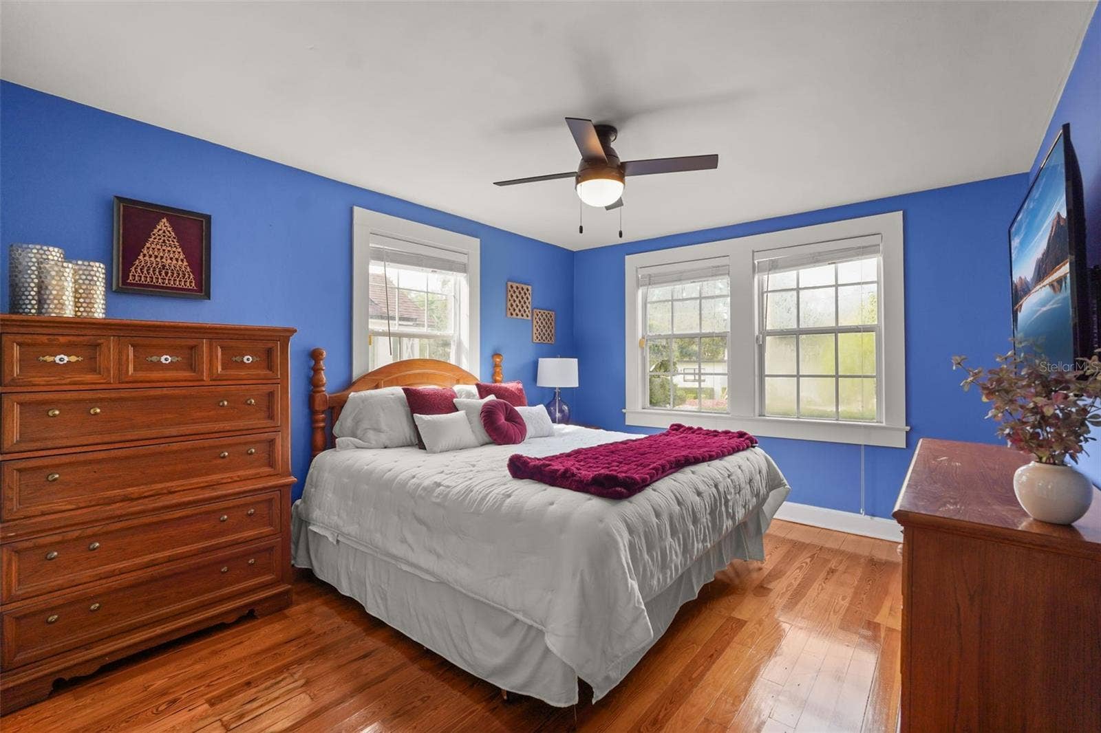 Bedroom with wood floors and ceiling fan