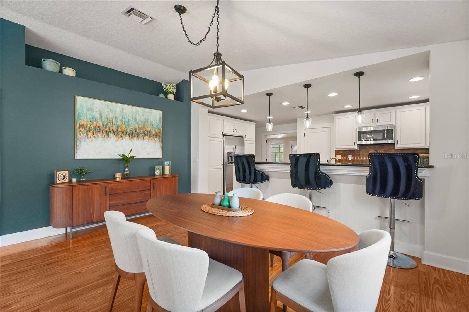 Dining area with lantern pendant and breakfast bar view