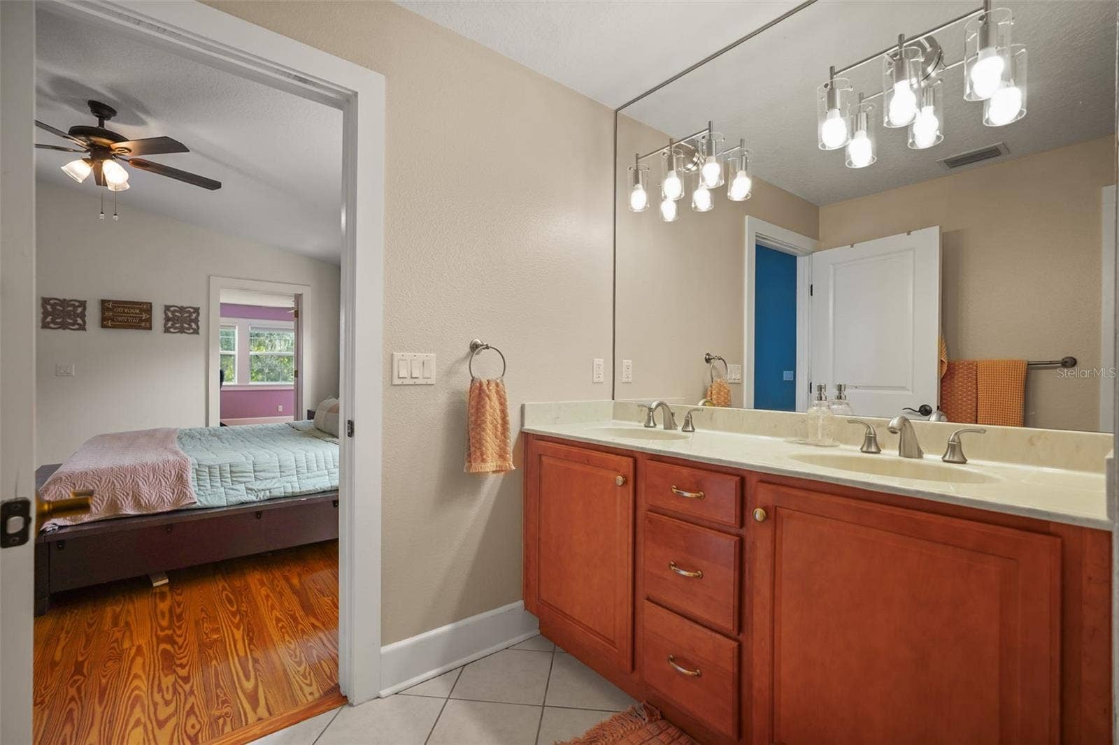 Primary bathroom dual vanity with view into the primary bedroom