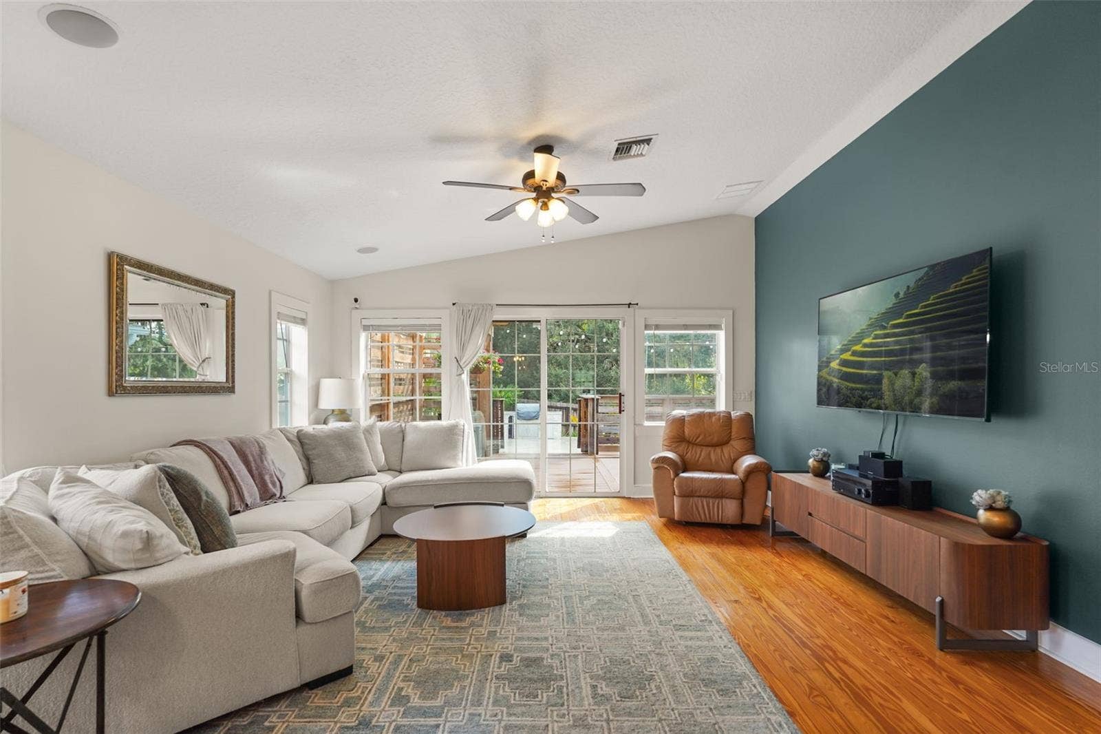 Living room with vaulted ceiling and accent wall