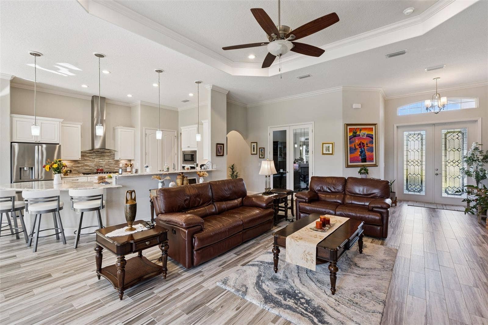 36819 WOLF COURT, Eustis, FL 32736 Beautifully updated kitchen featuring an expansive breakfast bar with seating for eight, seamlessly overlooking the spacious family room.