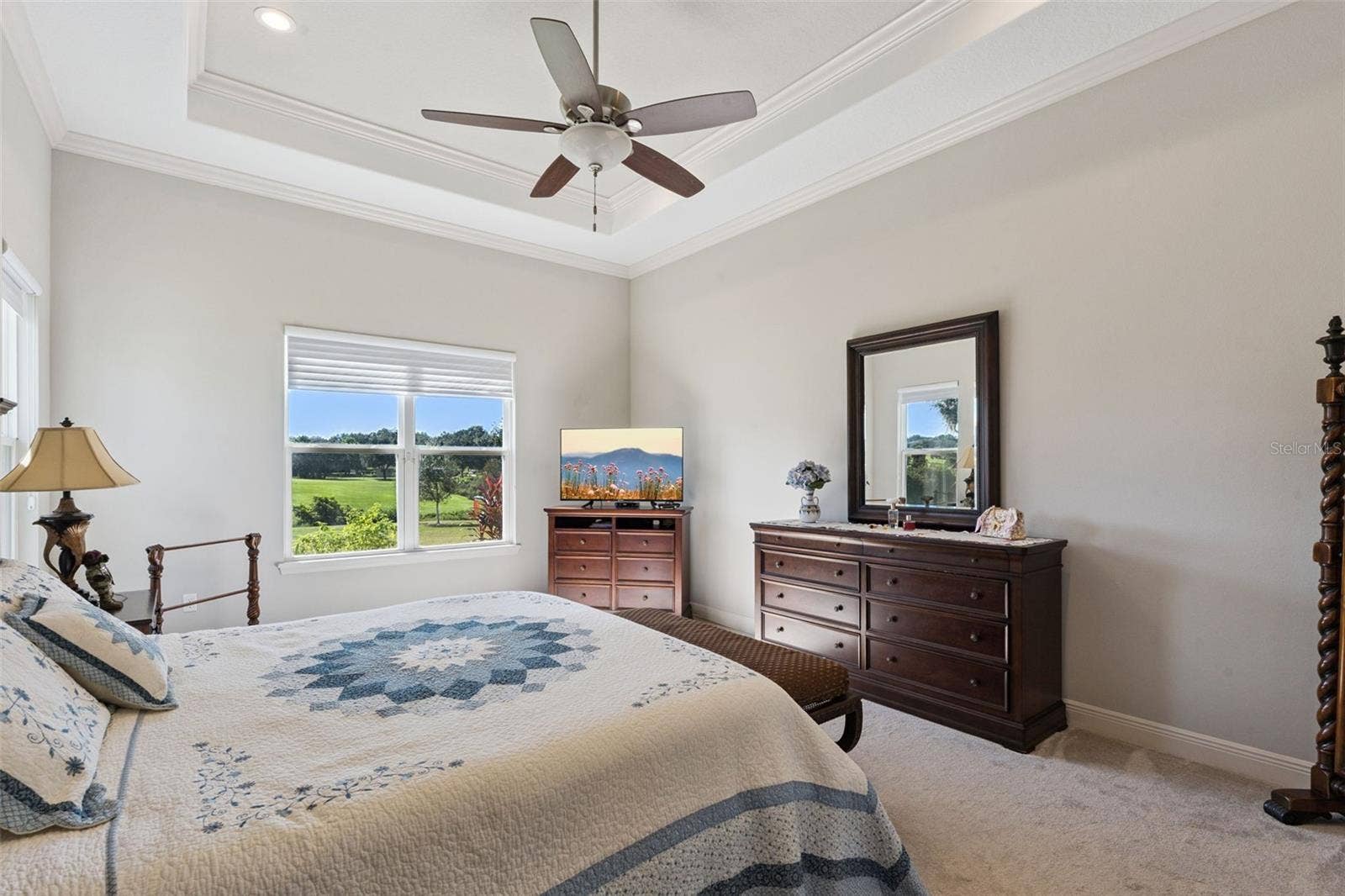 36819 WOLF COURT, Eustis, FL 32736 Spacious primary bedroom featuring a sophisticated trey ceiling, dual his-and-her closets, and a private en suite bathroom.