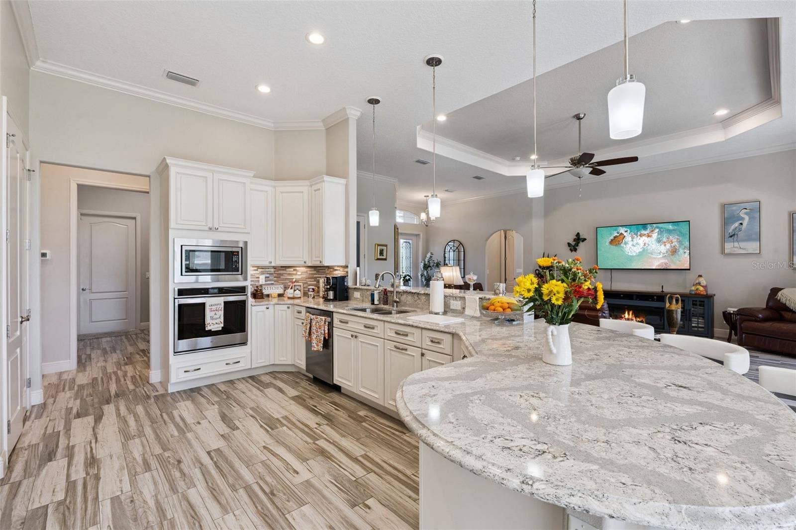 36819 WOLF COURT, Eustis, FL 32736 Enjoy family gatherings in the spacious kitchen, featuring a beautiful curved quartz island with comfortable seating for 8 or more.