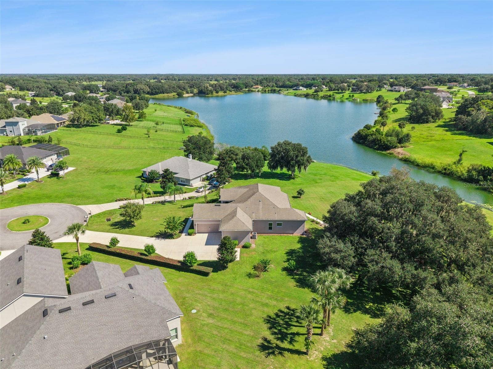 36819 WOLF COURT, Eustis, FL 32736 This property features a long, private driveway leading to an expansive estate.