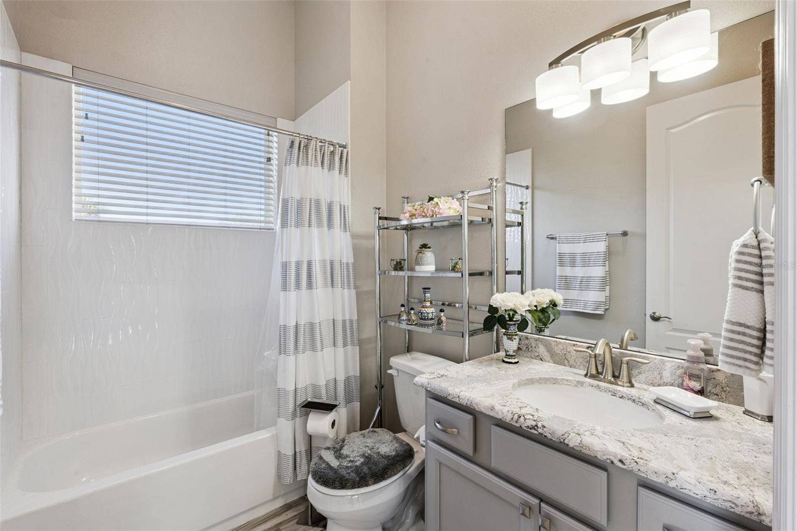 36819 WOLF COURT, Eustis, FL 32736 Bedroom 4/in law suite includes an en suite bathroom with shower/tub combo and quartz counters