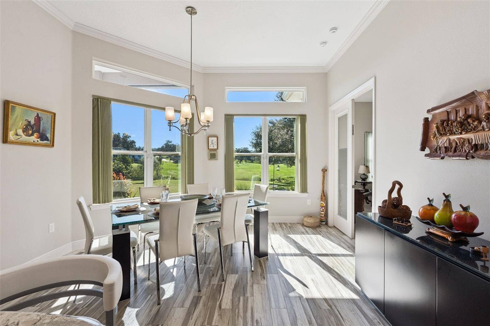 36819 WOLF COURT, Eustis, FL 32736 Enjoy expansive views with transom windows, complemented by a light, neutral paint palette that enhances the bright and airy atmosphere.