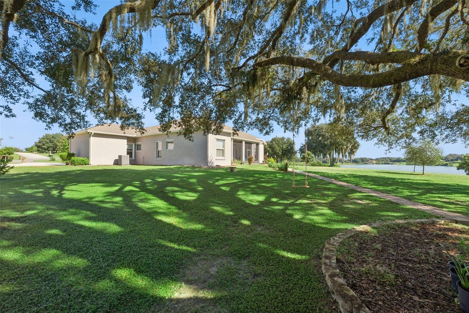 36819 WOLF COURT, Eustis, FL 32736 Exterior rear/side view with water view in the distance