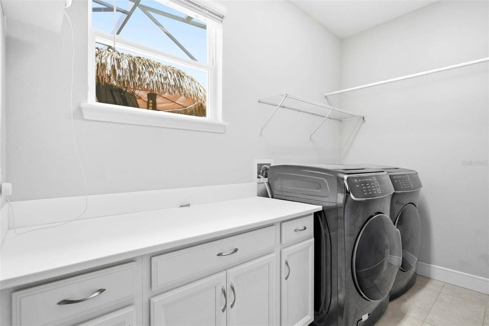 1552 MYRTLE OAKS TRAIL, Oviedo, FL 32765 Laundry room features cabinet and counter space along with a washer and dryer