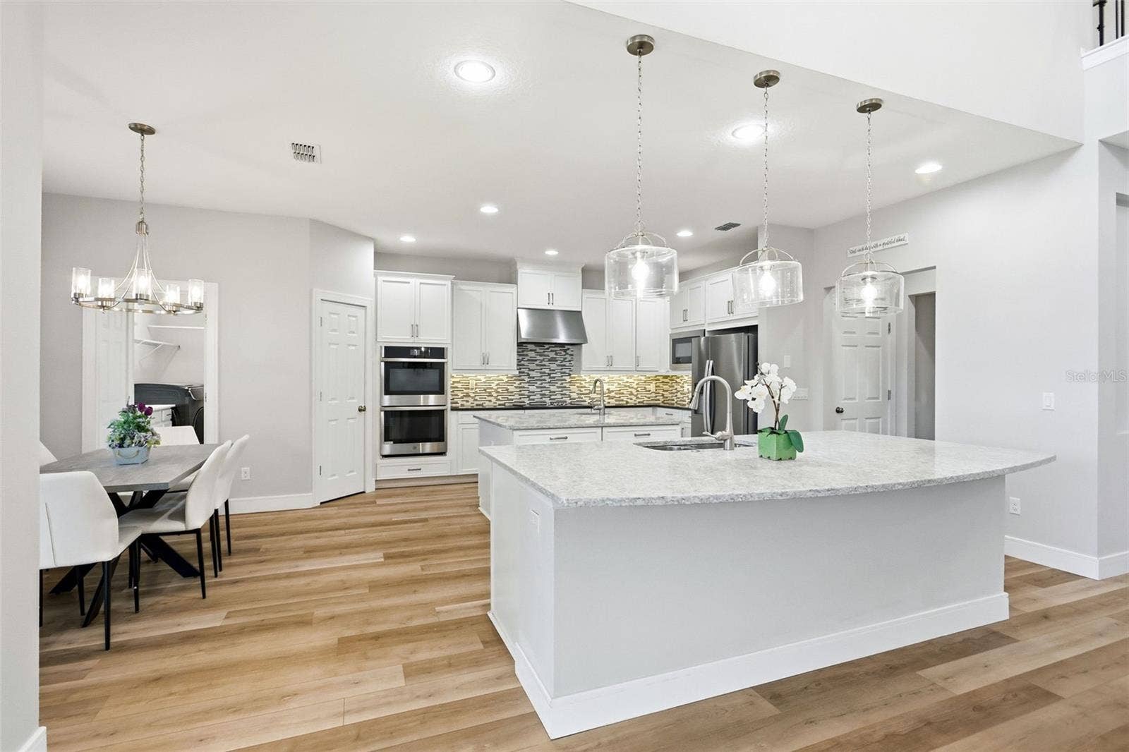 1552 MYRTLE OAKS TRAIL, Oviedo, FL 32765 Stunning kitchen featuring built in double ovens, walk-in pantry and beautiful lighting