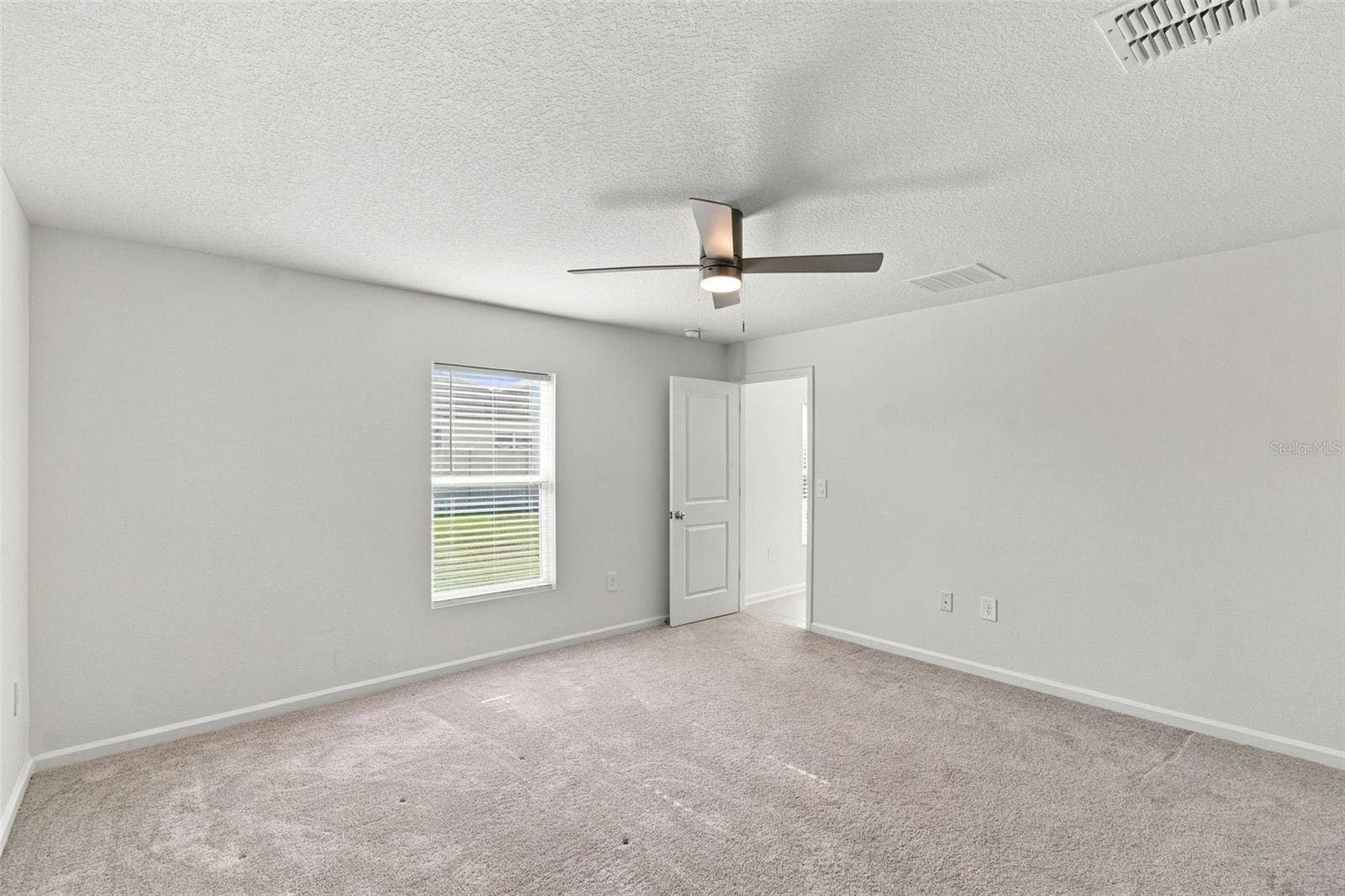 The private owners suite is tucked away at the back of the home and features an en-suite bathroom with dual sinks, a walk-in shower, and a generous walk-in closet.