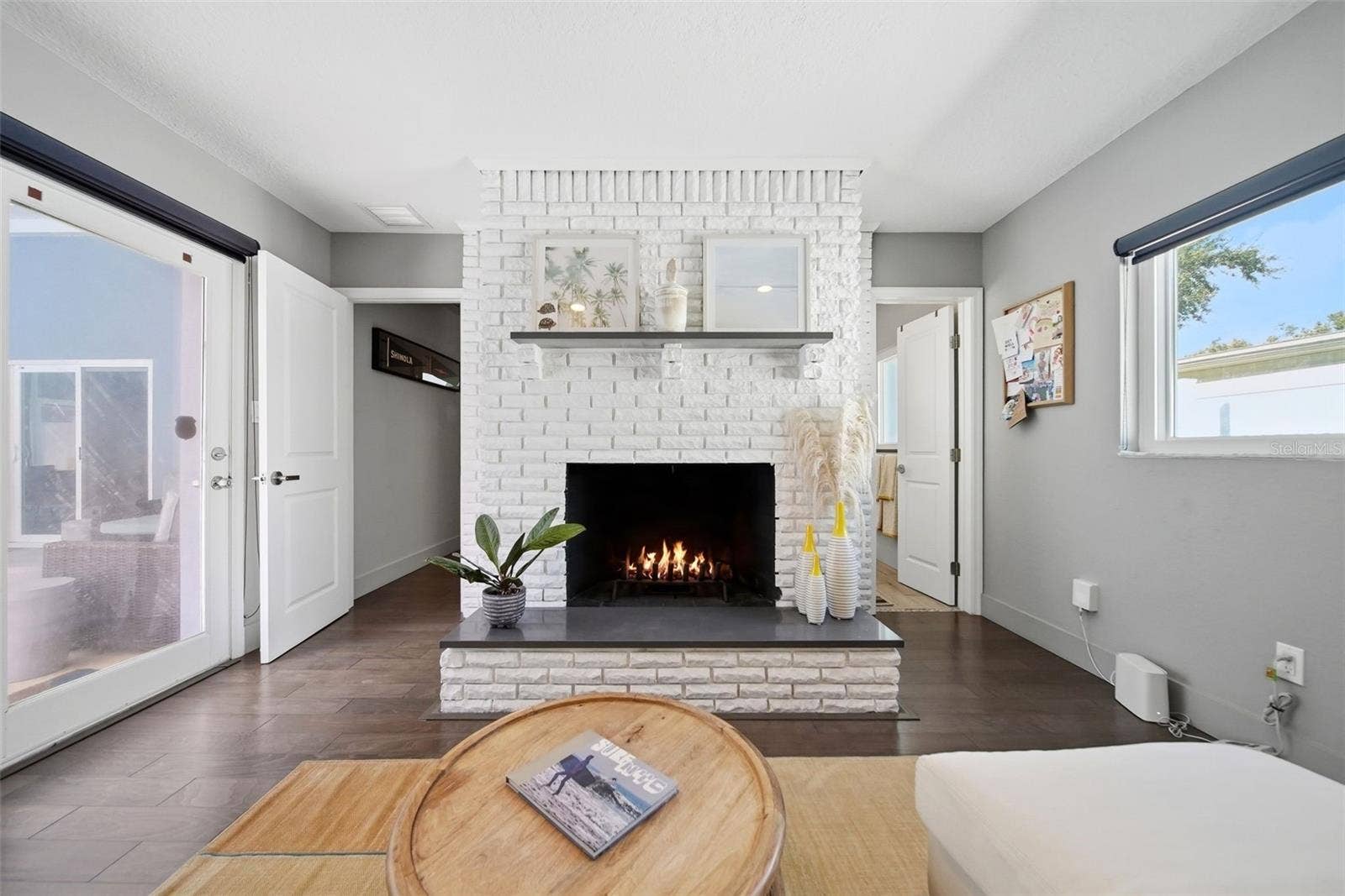 Primary suite with wood-burning fireplace and sliders to the pool