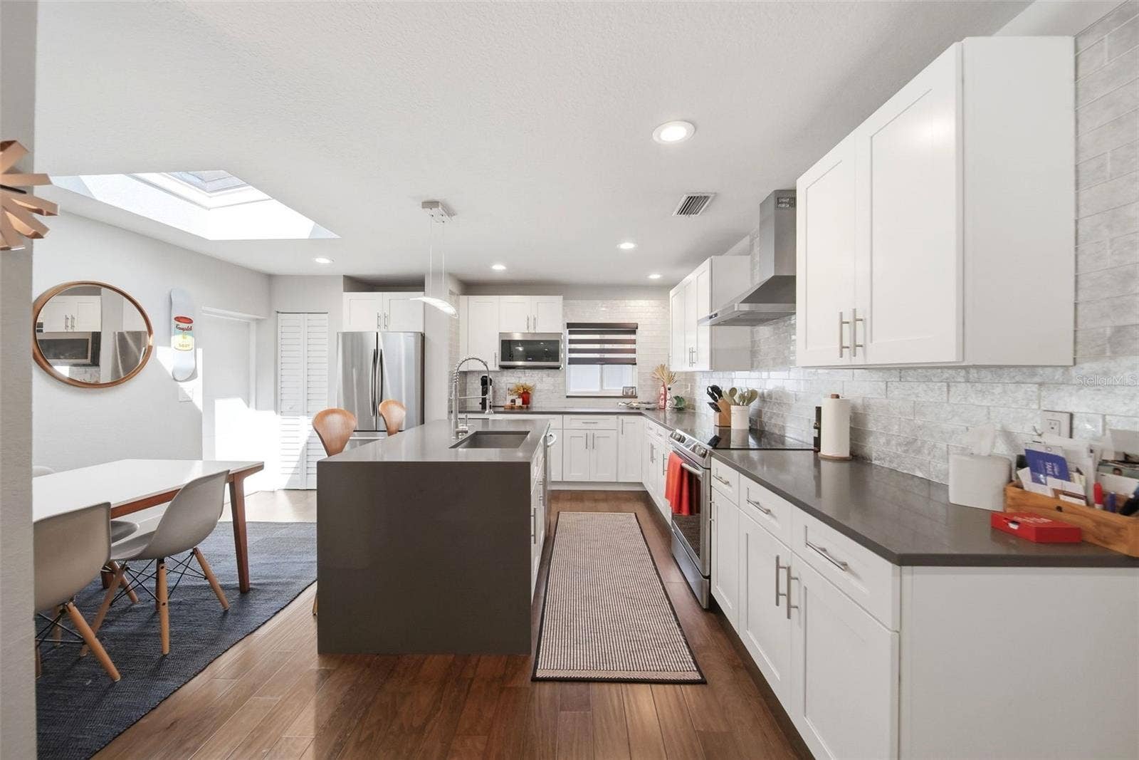 The skylight allows natural light to pour into the dining area and kitchen