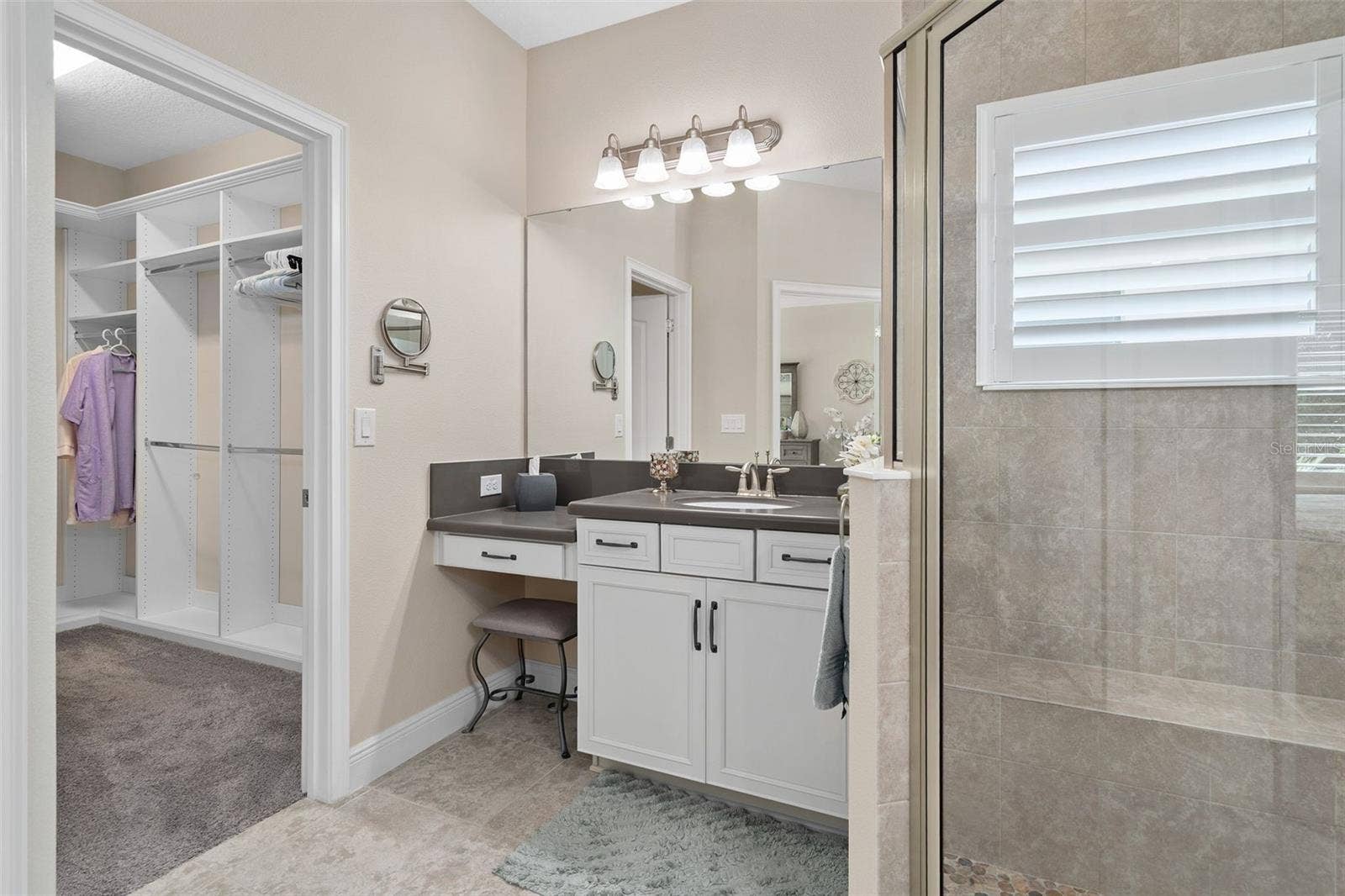 2607 CLEMSON RIDGE COURT, Clermont, FL 34715 Primary En-Suite offering Comfort Height split vanities, Quartz Counters and a custom Organized Walk-in closet.