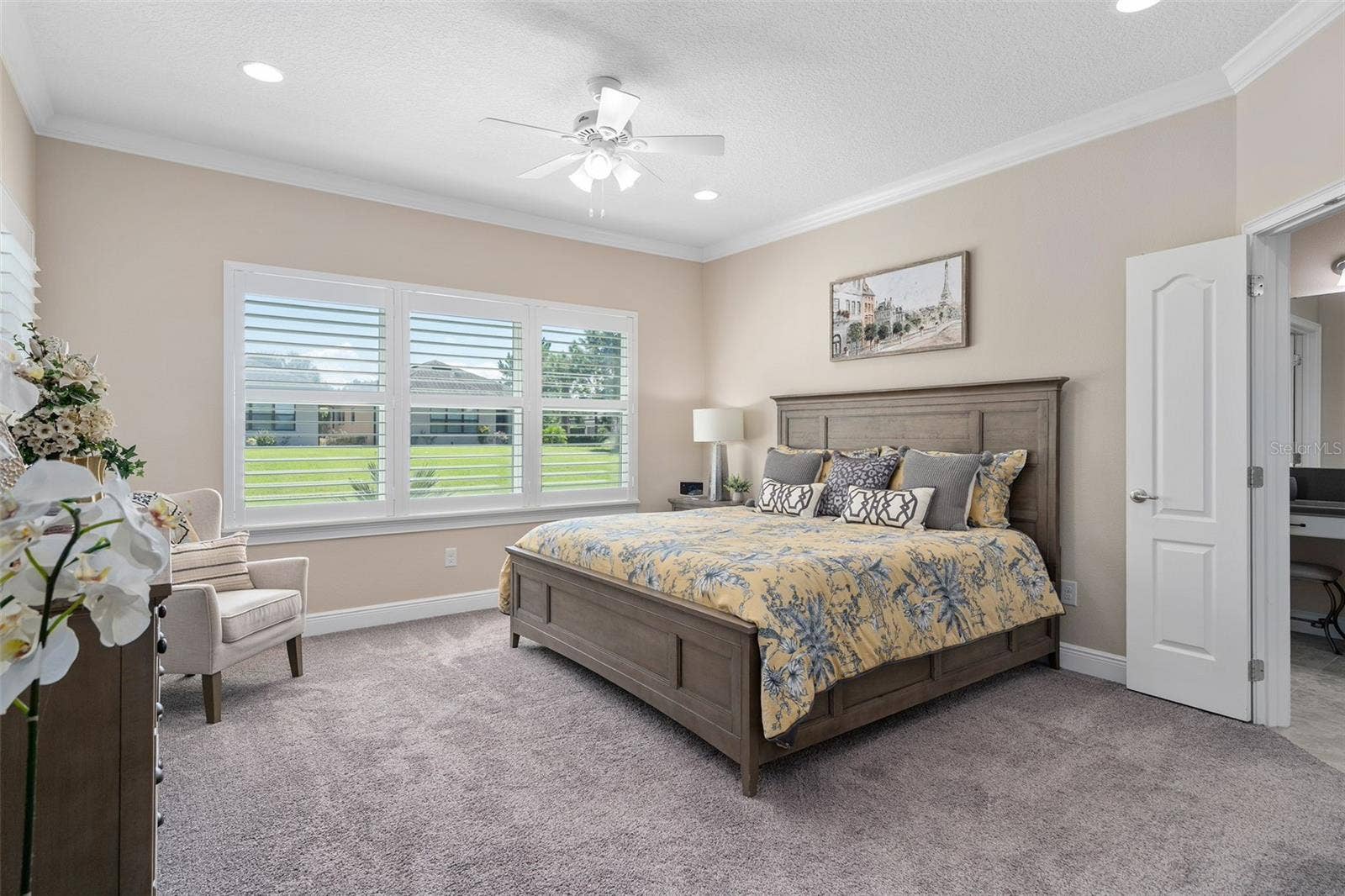 2607 CLEMSON RIDGE COURT, Clermont, FL 34715 Primary Bedroom is spacious offering great natural light, Plantation Shutters, additional ceiling lighting plus a fan, Crown Molding, Walk-in Custom Organized Closet and a great En-Suite.