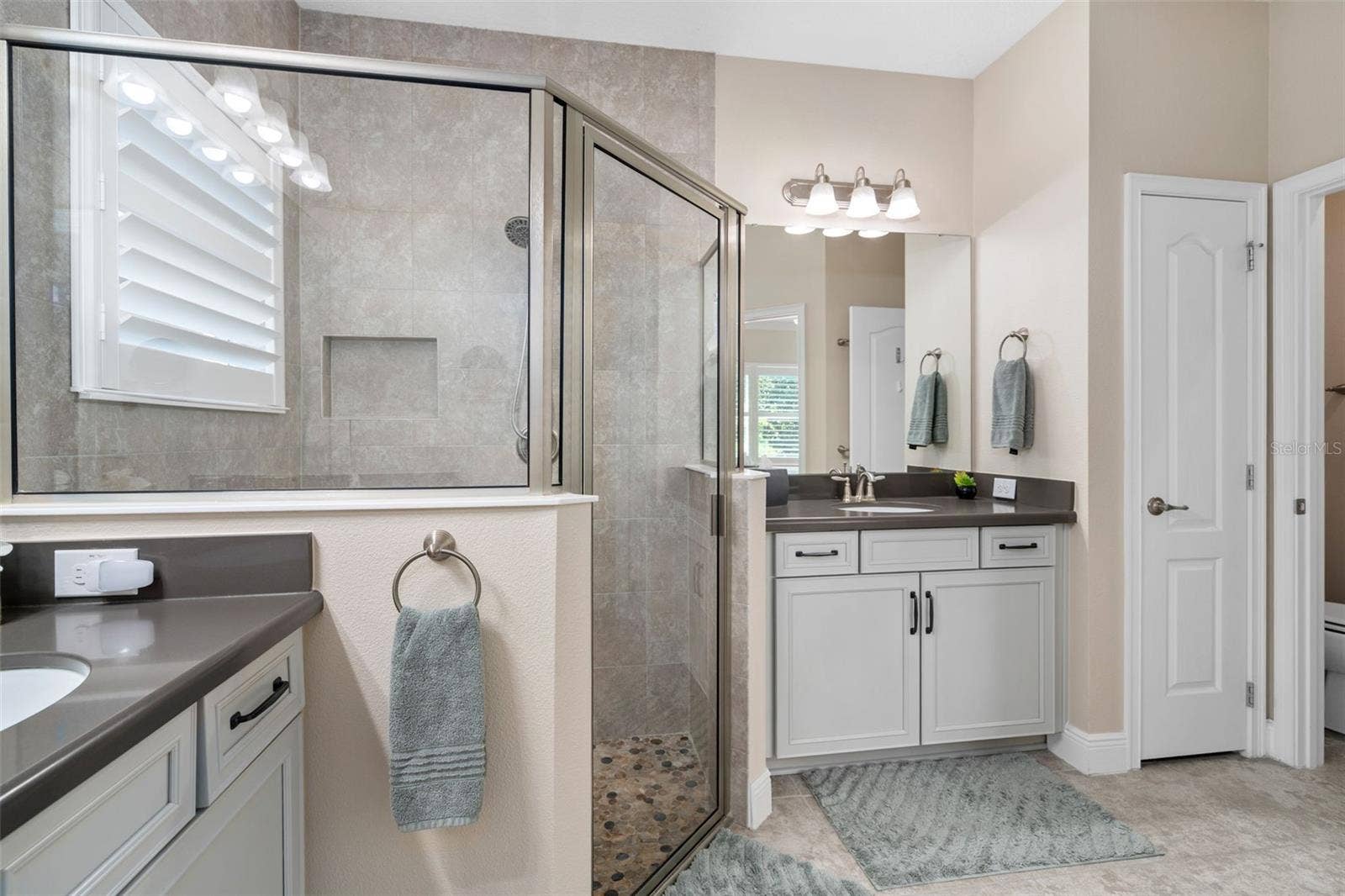 2607 CLEMSON RIDGE COURT, Clermont, FL 34715 The Primary En-Suite Shower offers Upgraded Wall and Floor Tile. There is also a Linen closet and Water Closet.