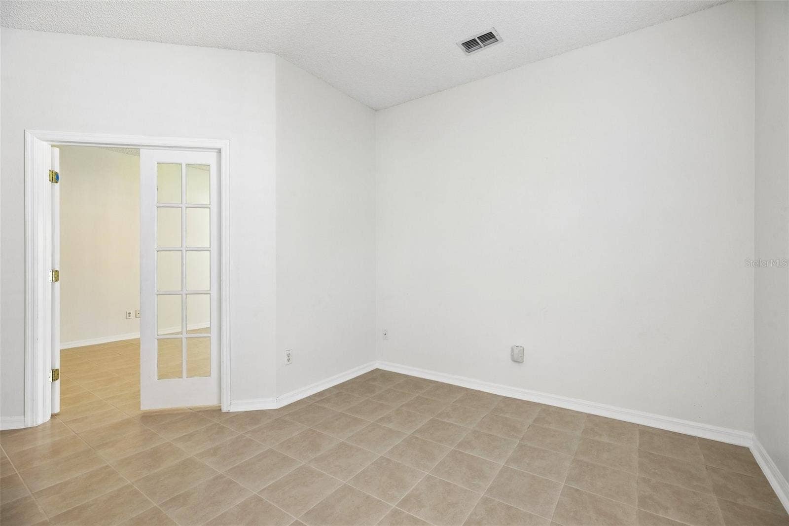 1806 ANNA CATHERINE DRIVE, Orlando, FL 32828 Glass-paneled French doors lead from the Primary Suite to a BONUS ROOM that could serve as a home office, nursery, hobby room, or POTENTIAL FOURTH BEDROOM, depending on your needs.
